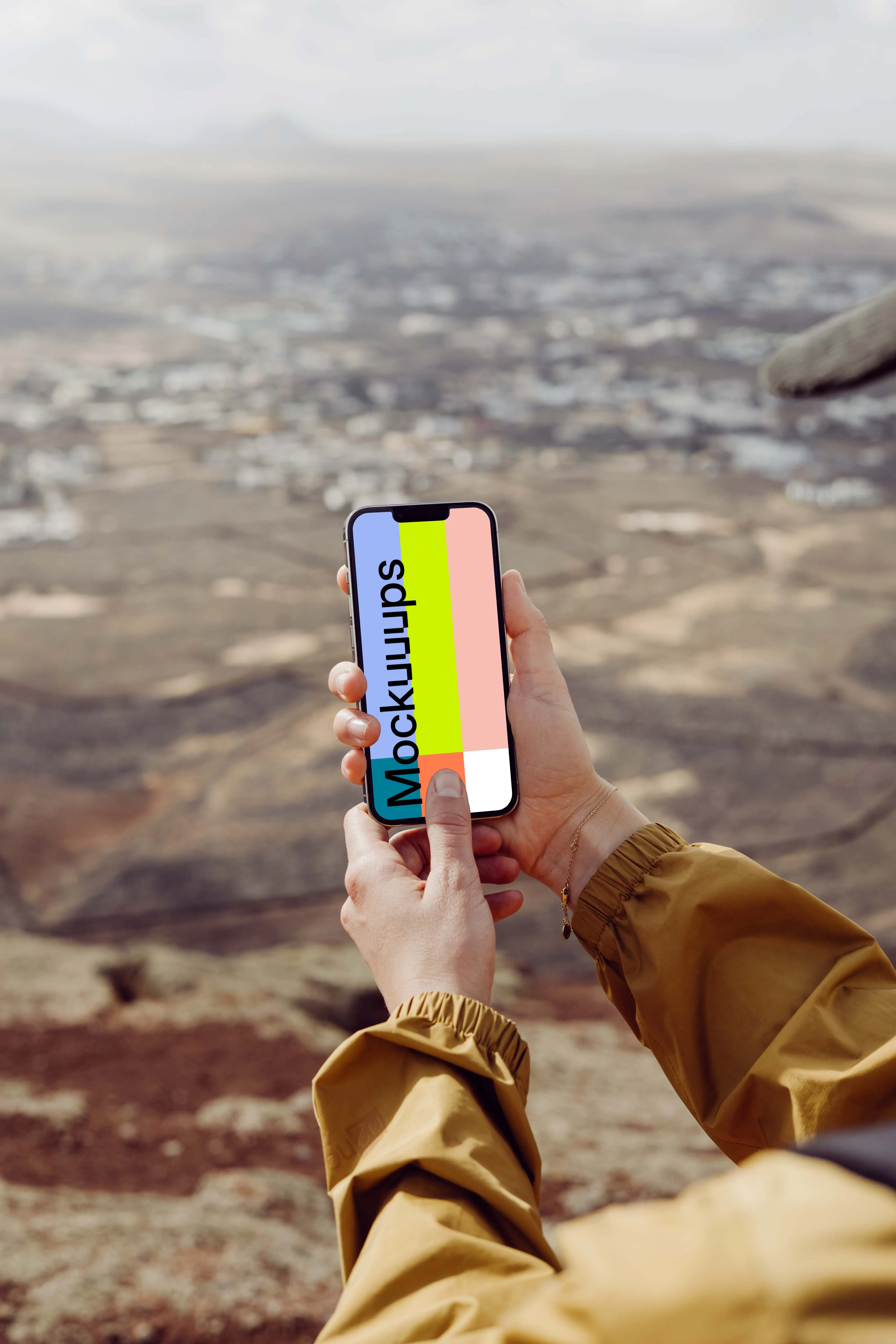 iPhone 13 Pro mockup held with both hands by a user outdoors