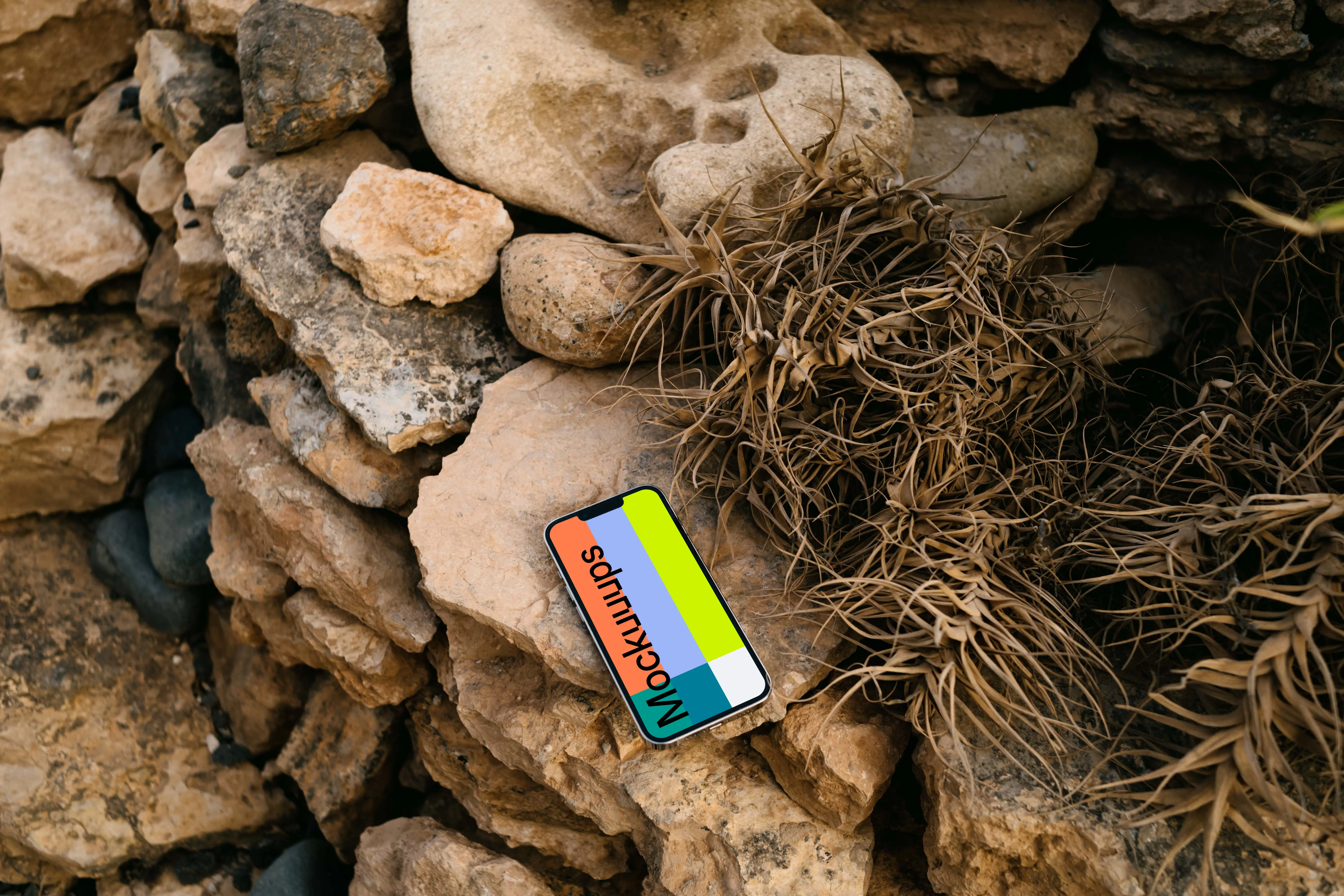 iPhone 13 Pro mockup on stacked rocks