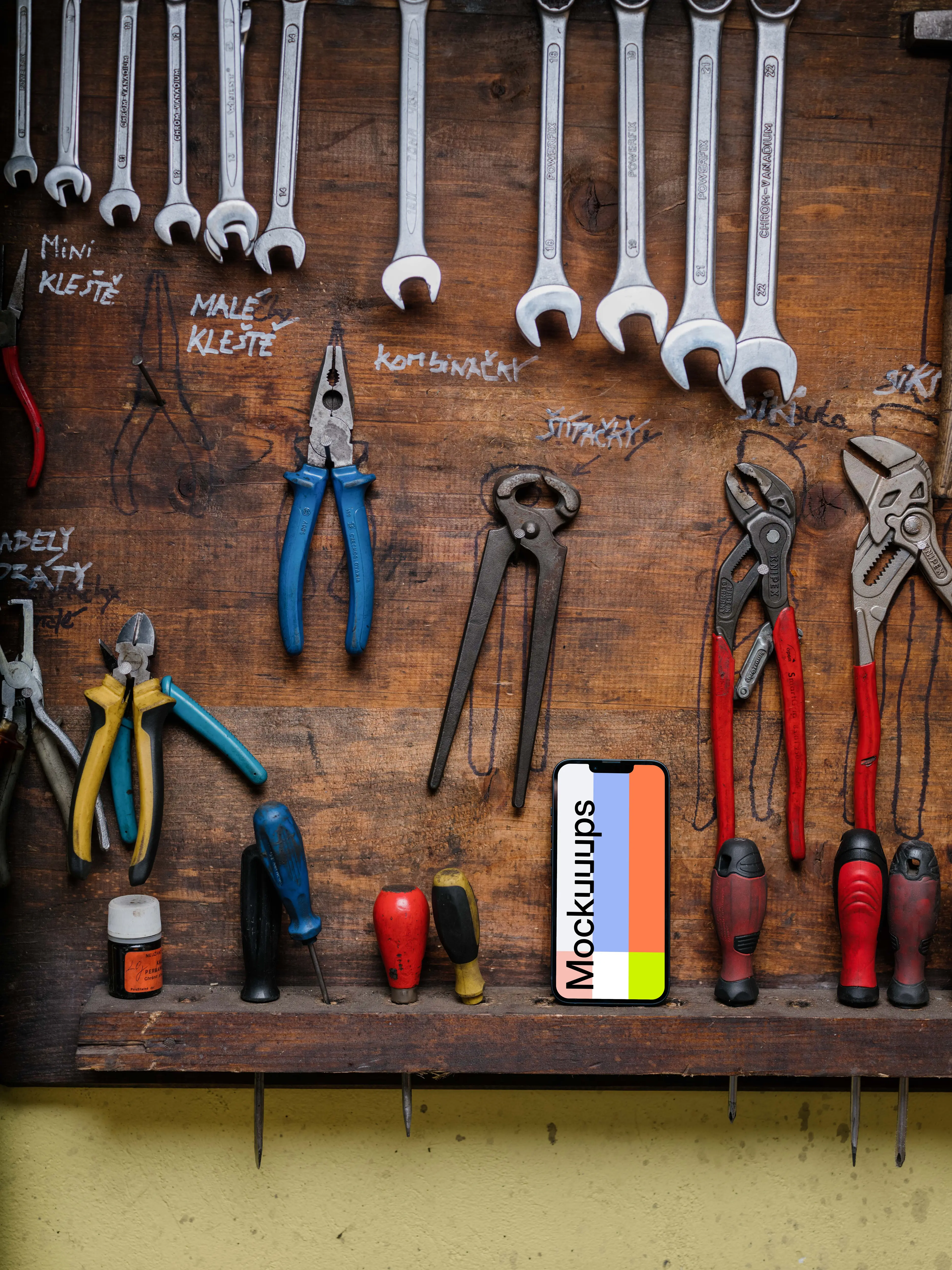 iPhone 13 Pro mockup placed next to a couple of tools