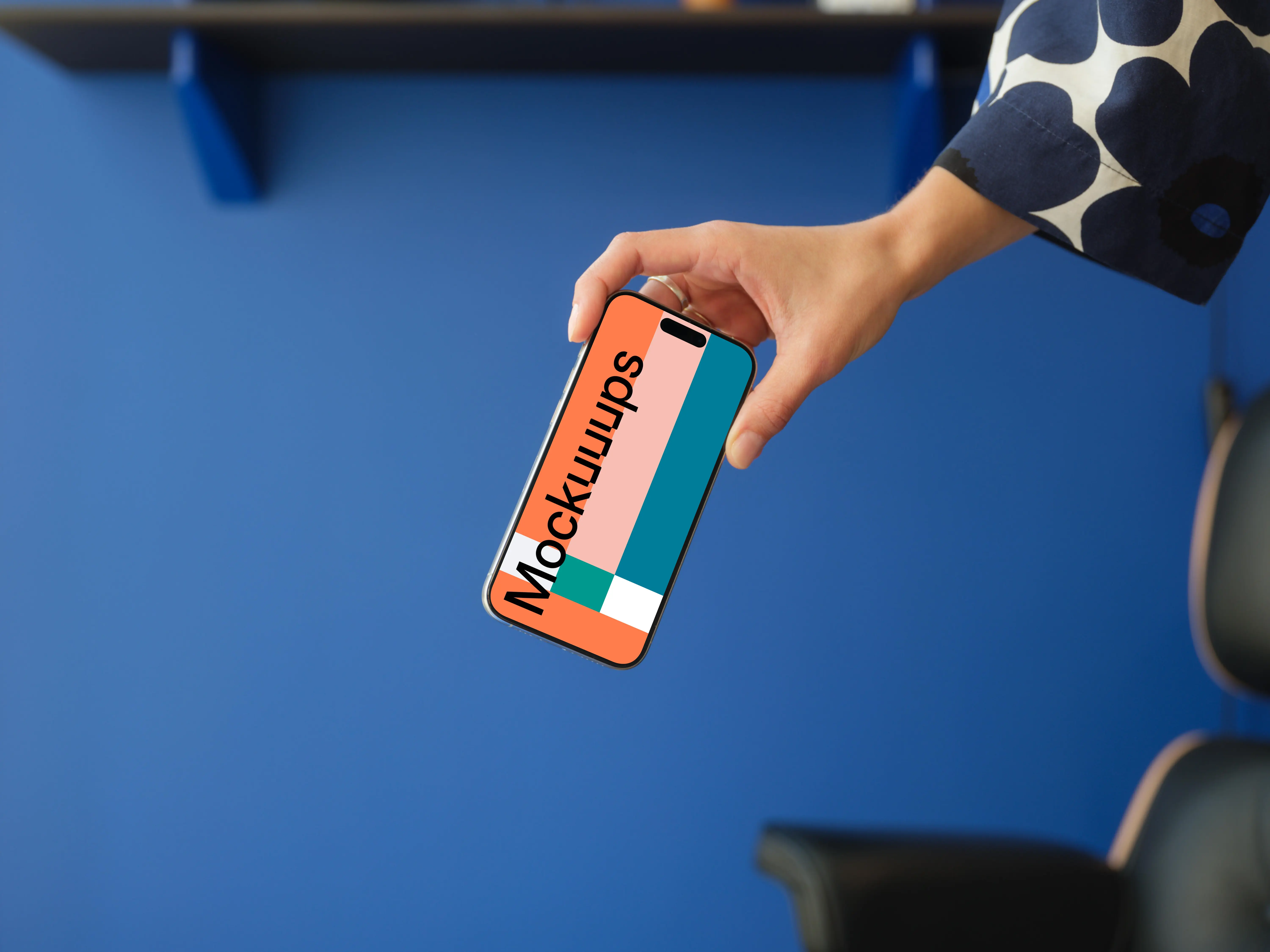 iPhone 15 Pro mockup in a woman's hand against a blue background