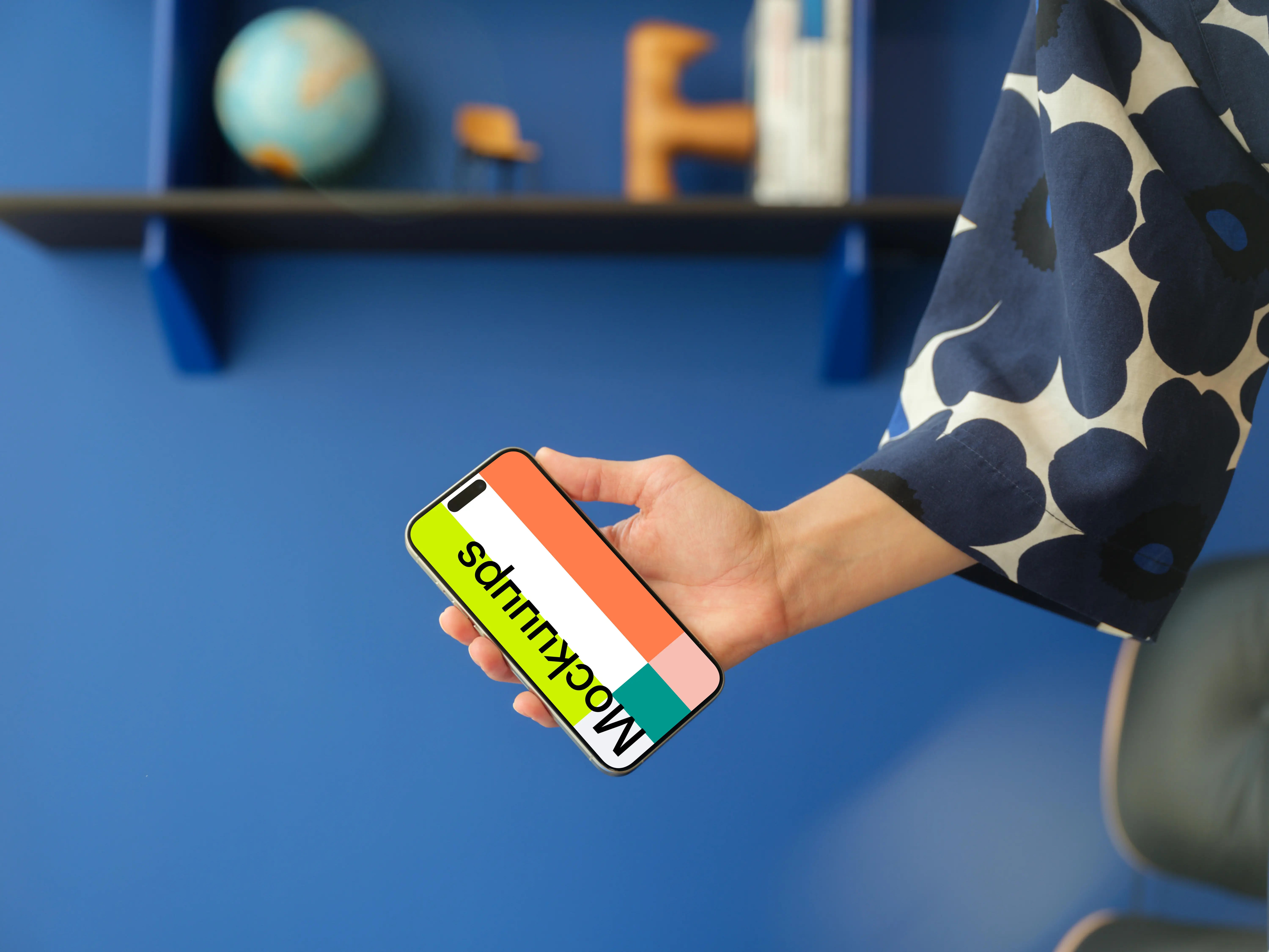 iPhone 15 Pro mockup in a woman's hand against a modern blue wall