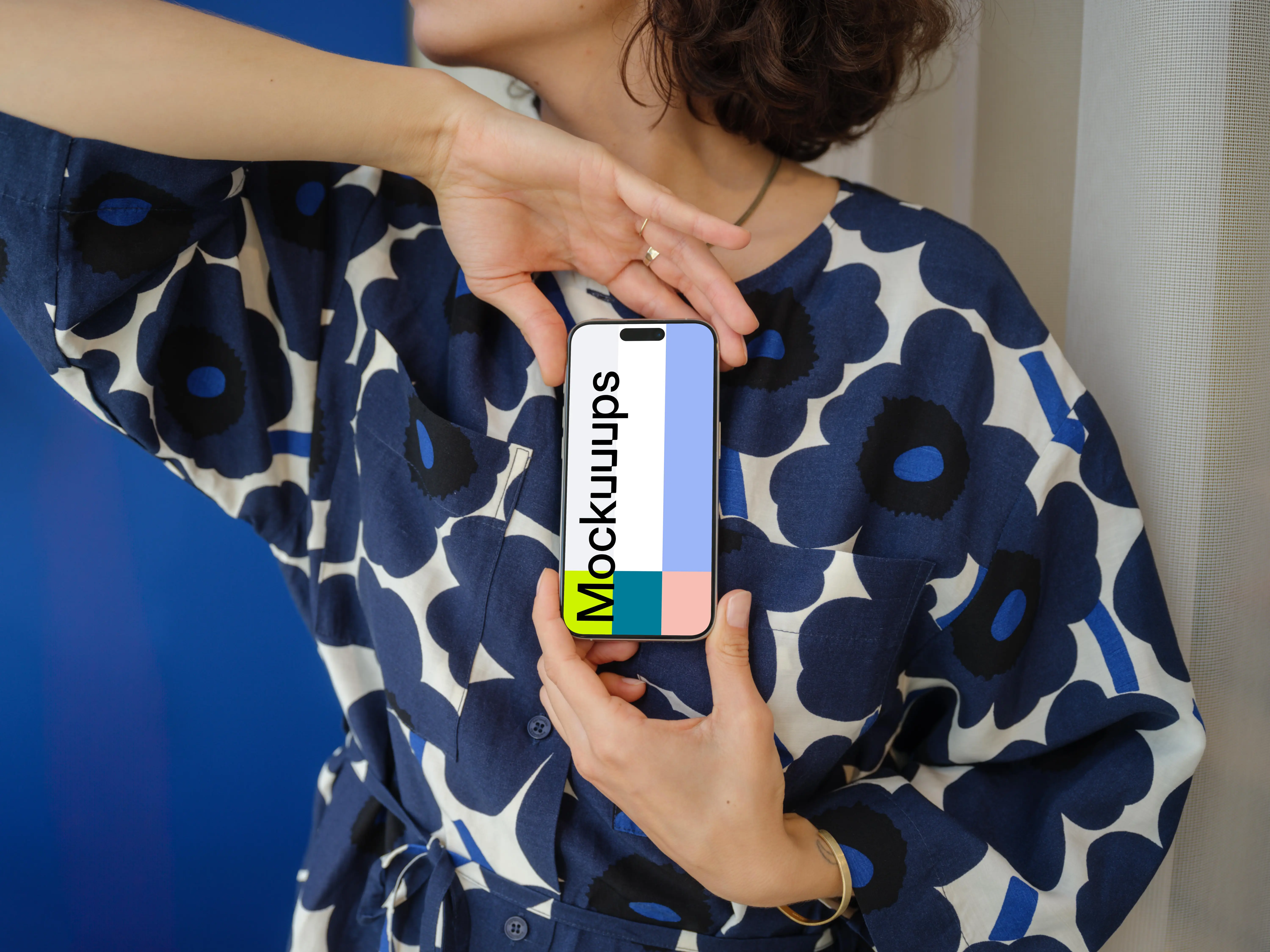 iPhone 15 Pro mockup in a woman's hand with floral outfit