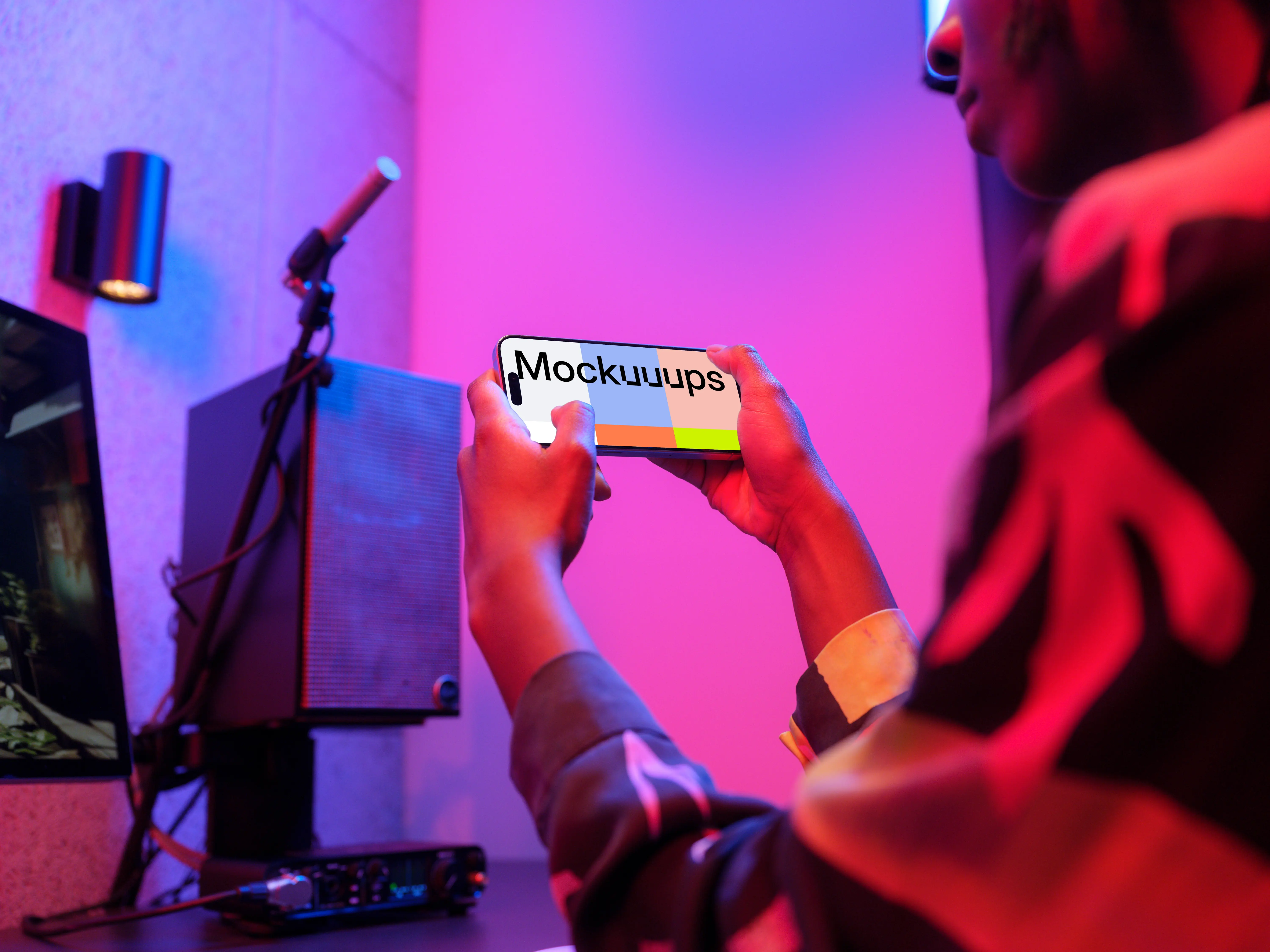 iPhone 15 Pro mockup in gamer's hands with dynamic lighting