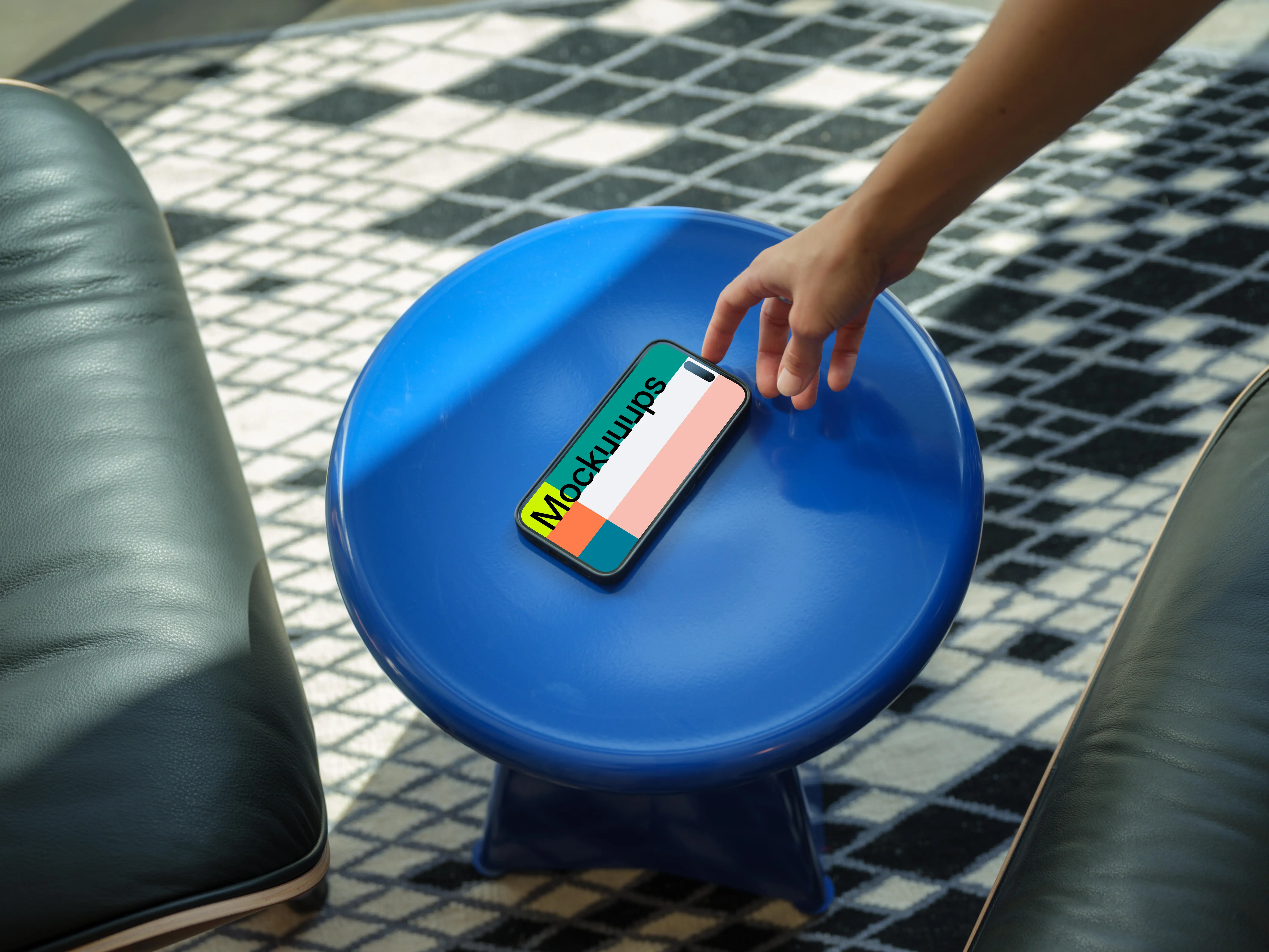 iPhone 15 Pro mockup with female hand on a blue stool
