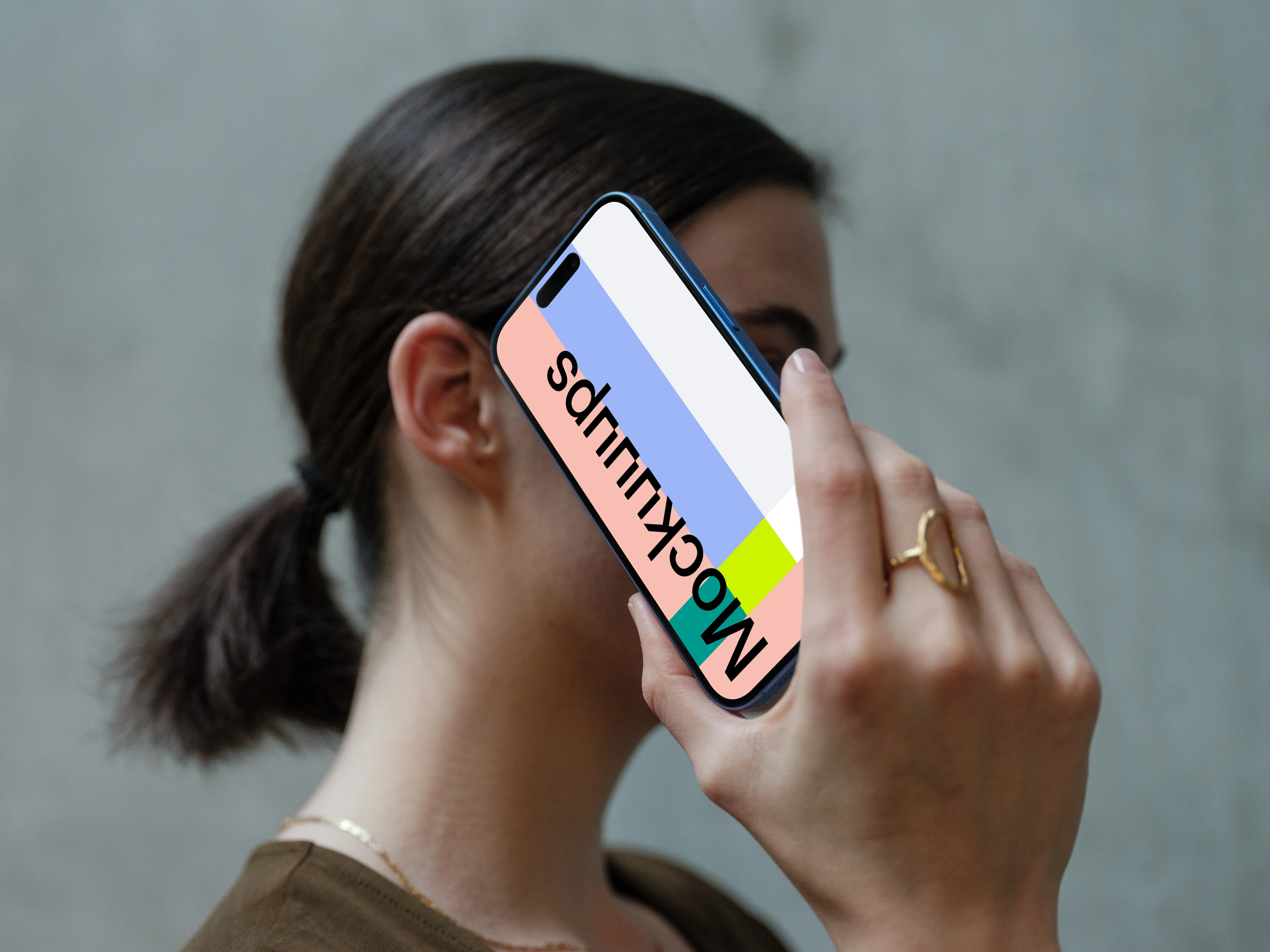 iPhone 16 mockup held in hand against concrete background