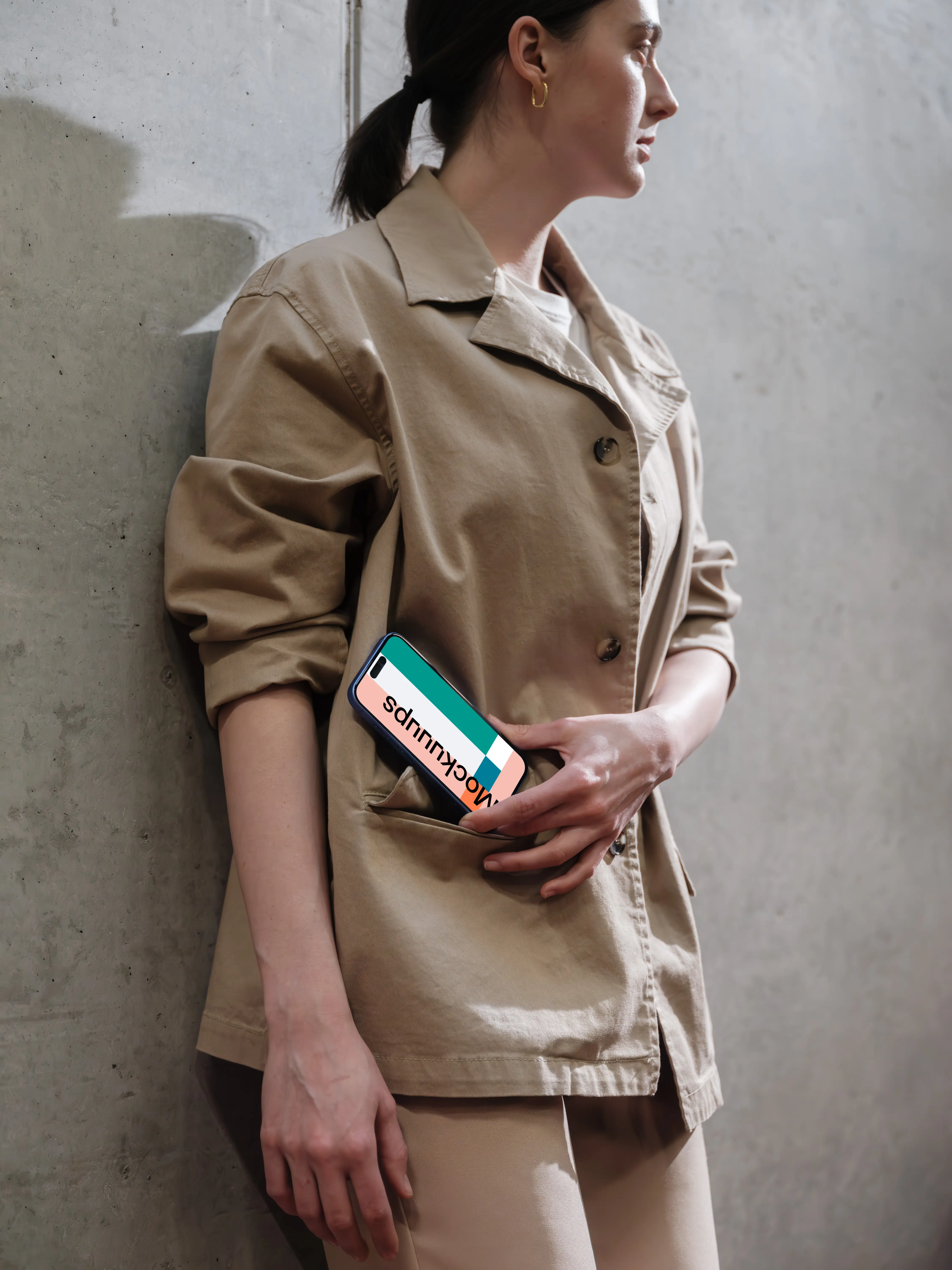 iPhone 16 mockup in woman's hand on concrete background