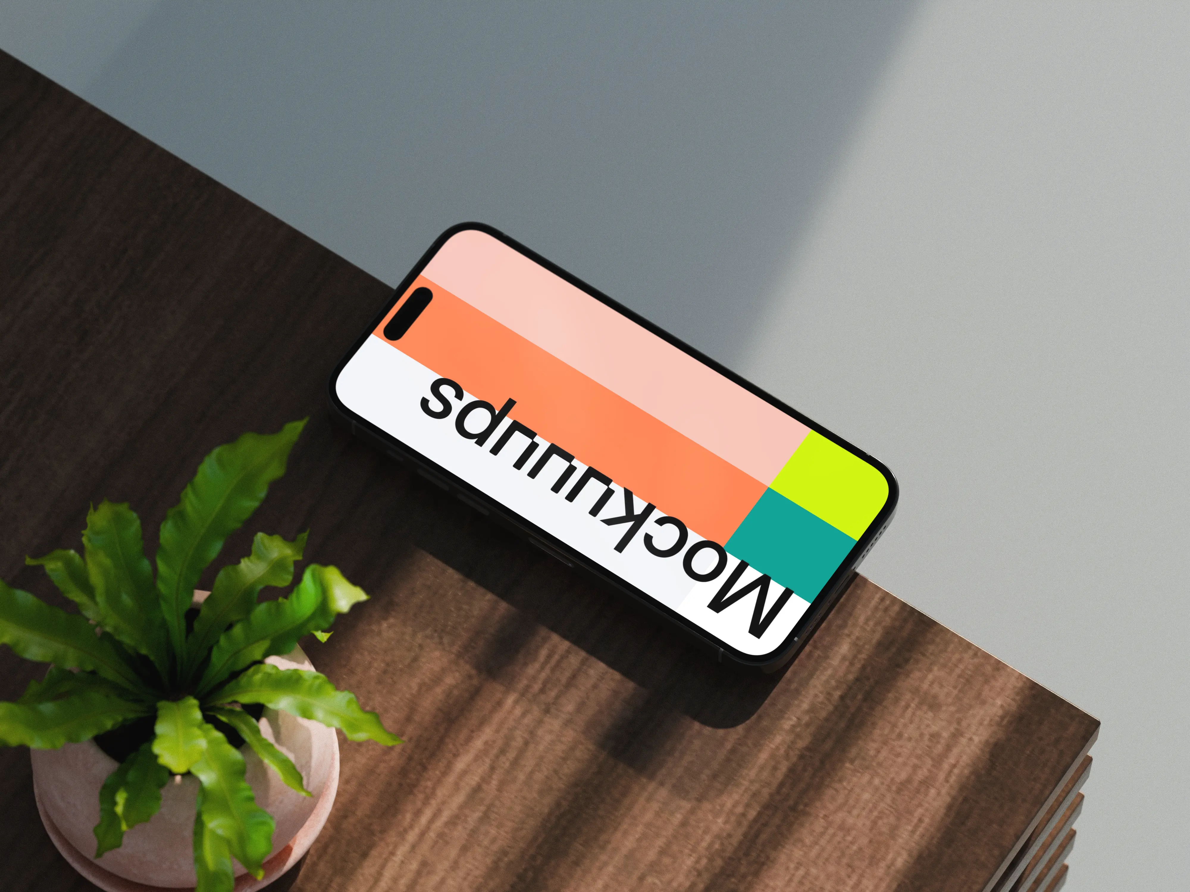 iPhone 17 mockup on a wooden desk with a plant
