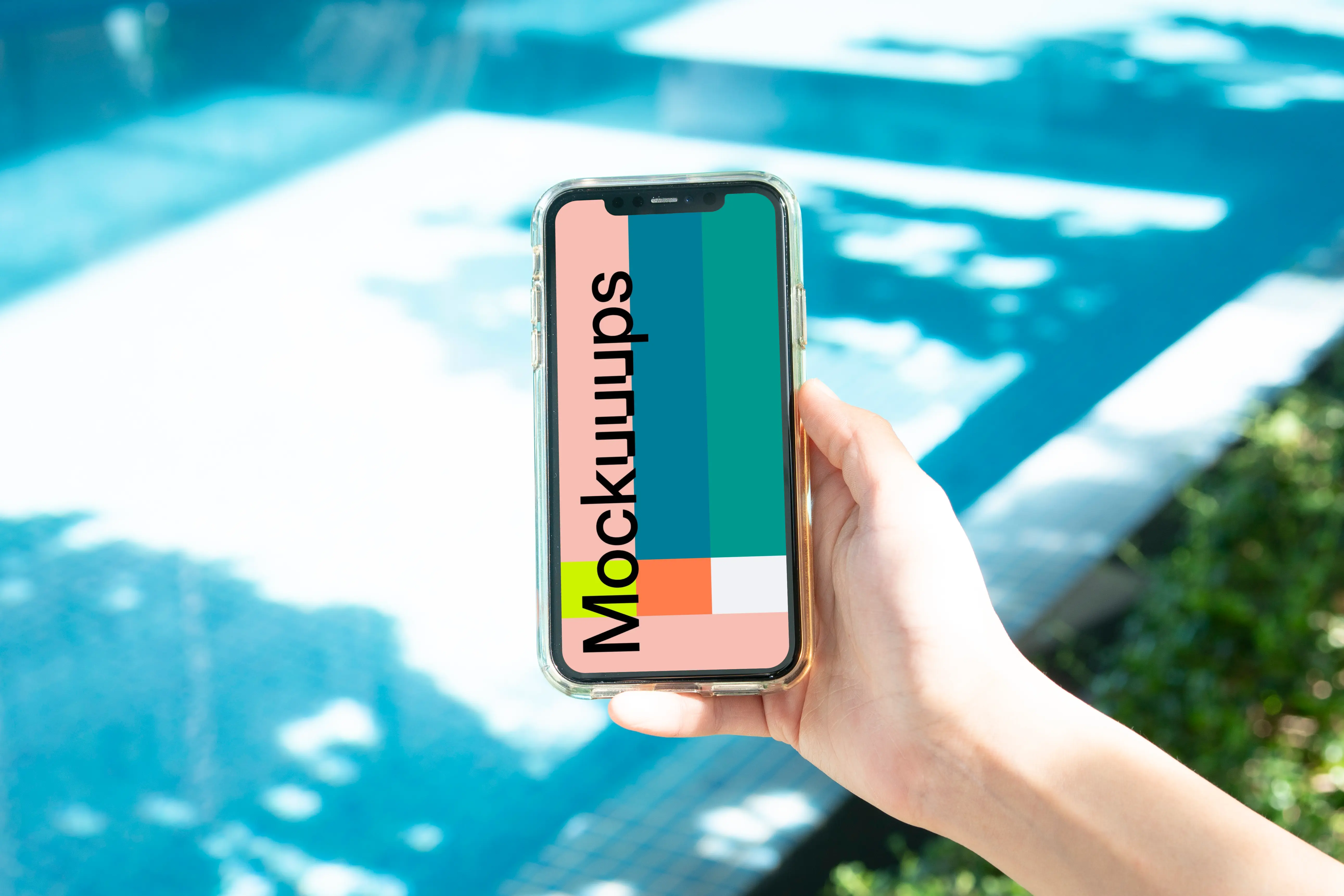 iPhone held beside a swimming pool