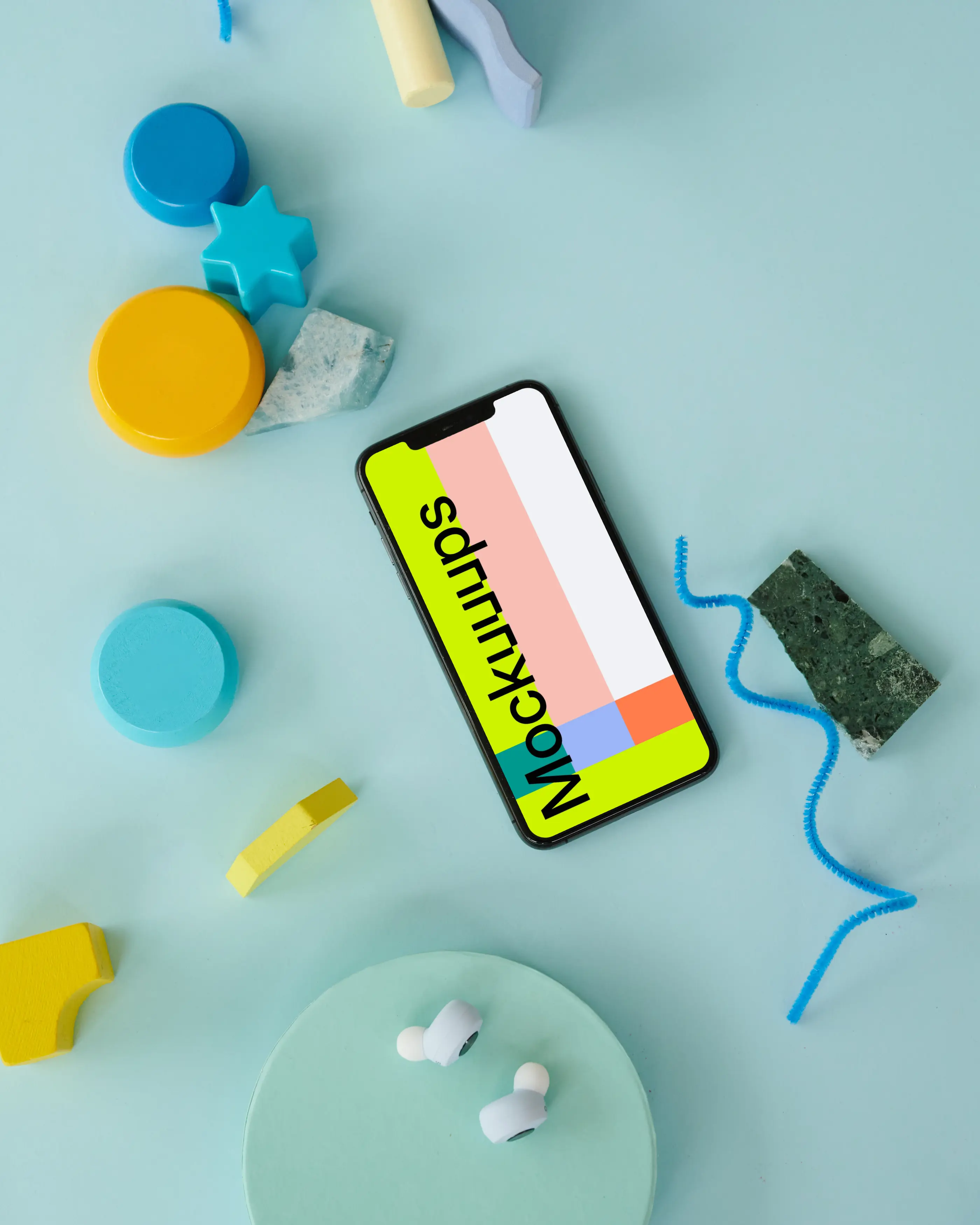 iPhone mockup on a blue table beside a pair of ebuds