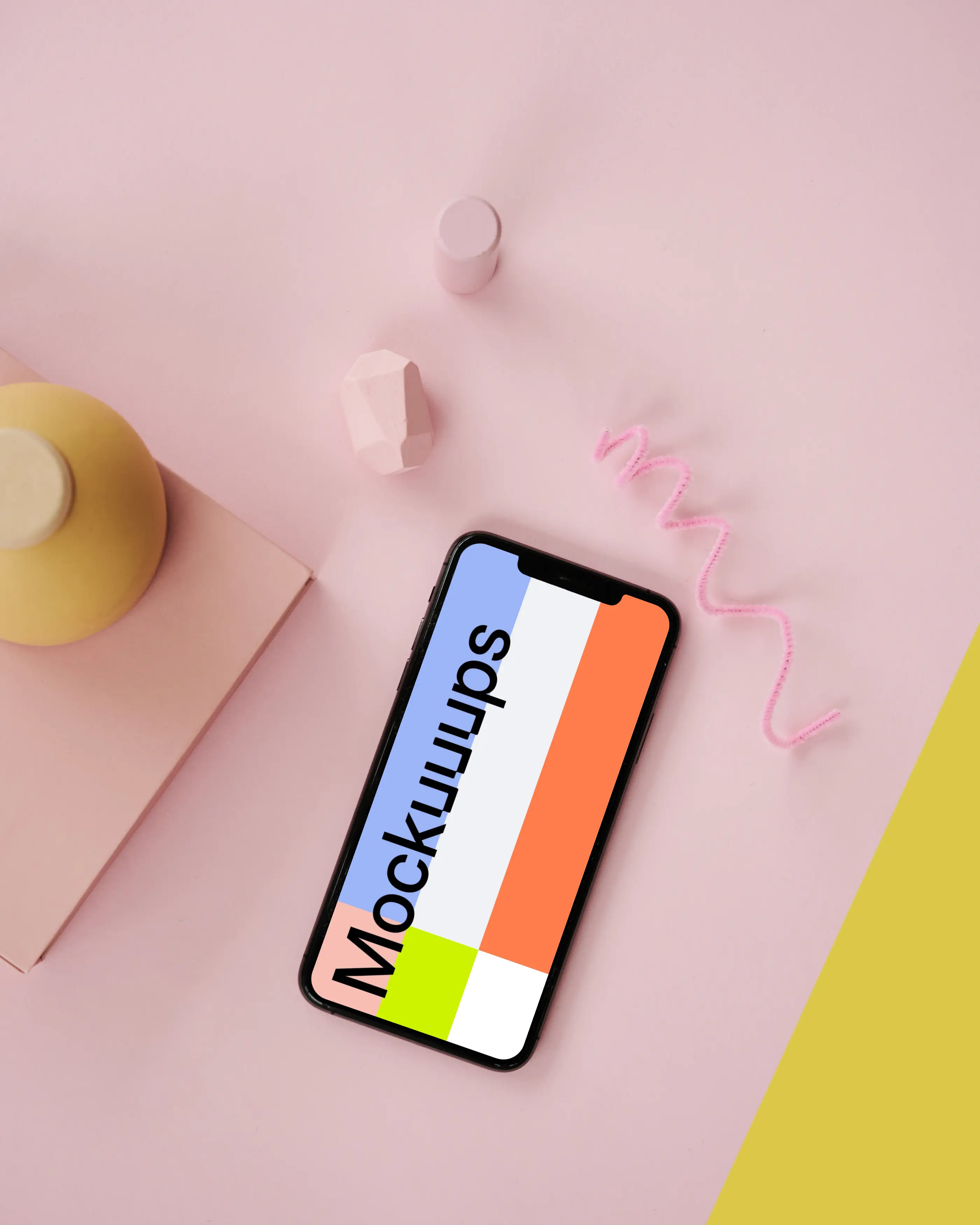 iPhone mockup on a pink table