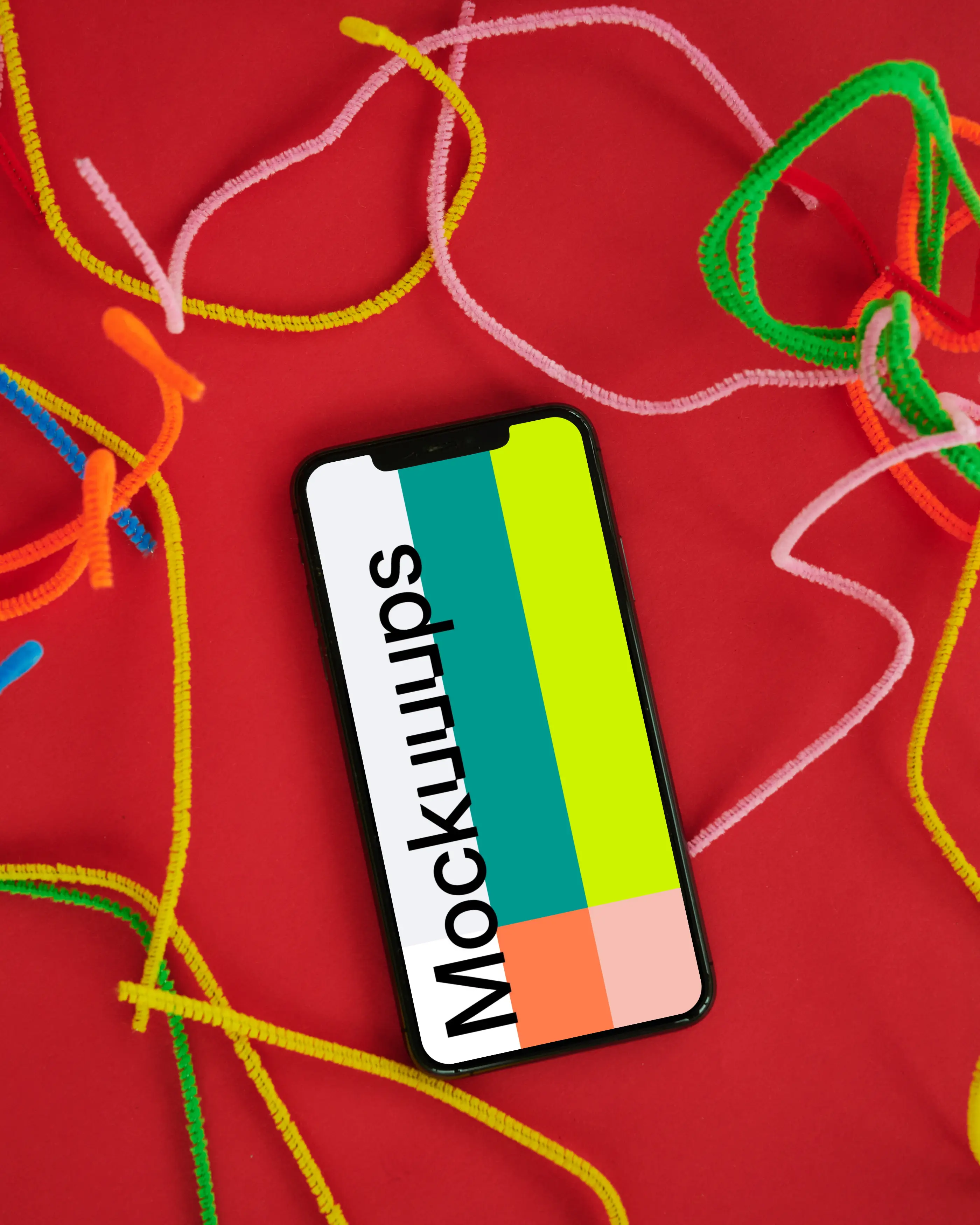 iPhone mockup on a red table