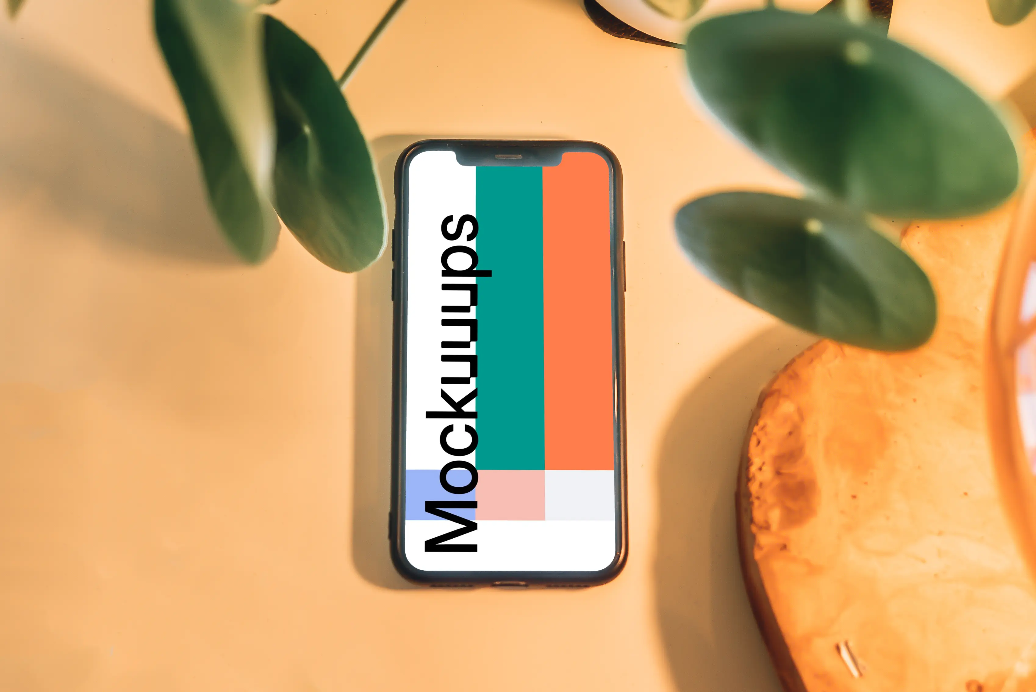 iPhone mockup underneath with leaves in foreground