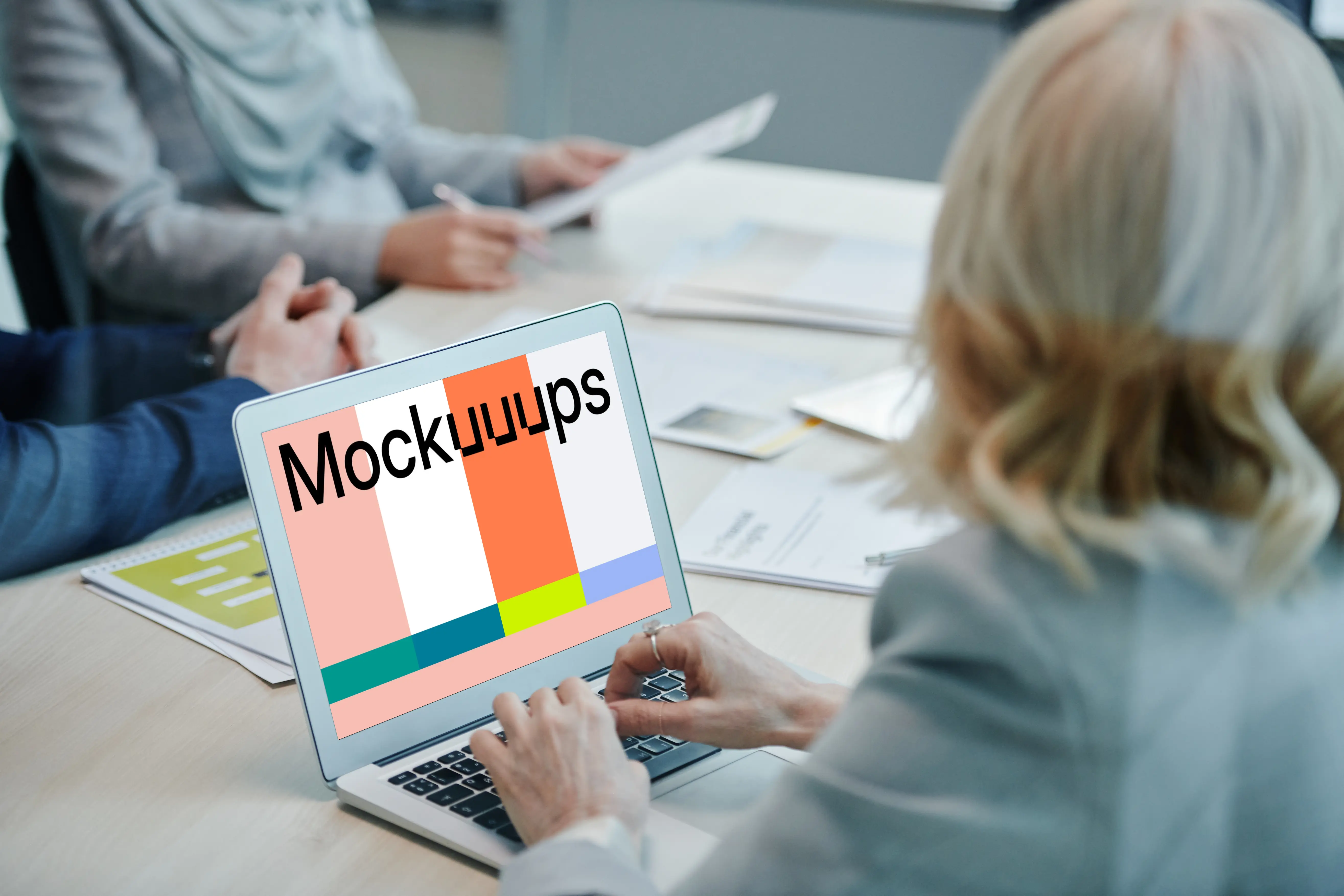 Lady at a conference table using a MacBook Air mockup