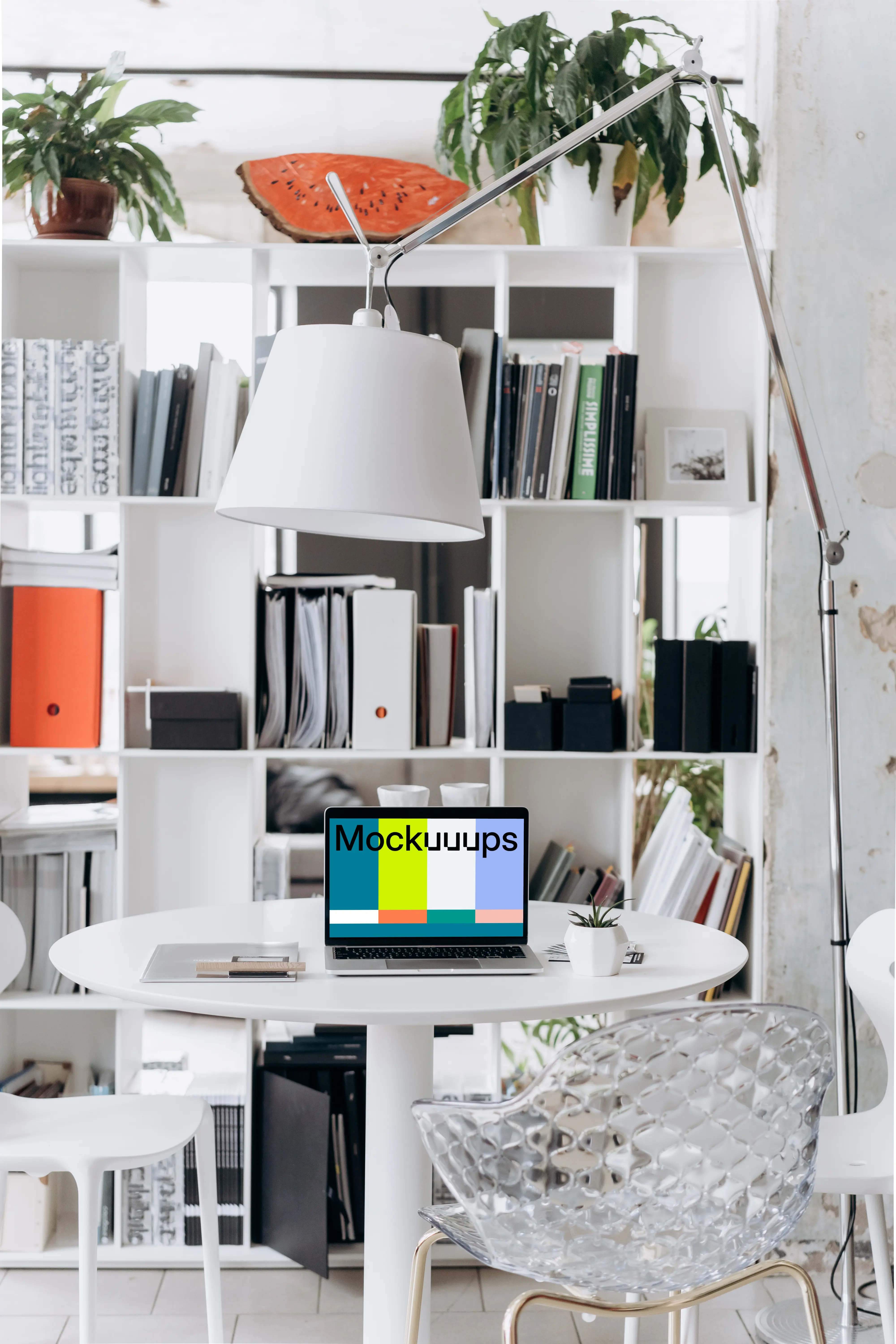 Laptop mockup in an office setting with overhead lamp