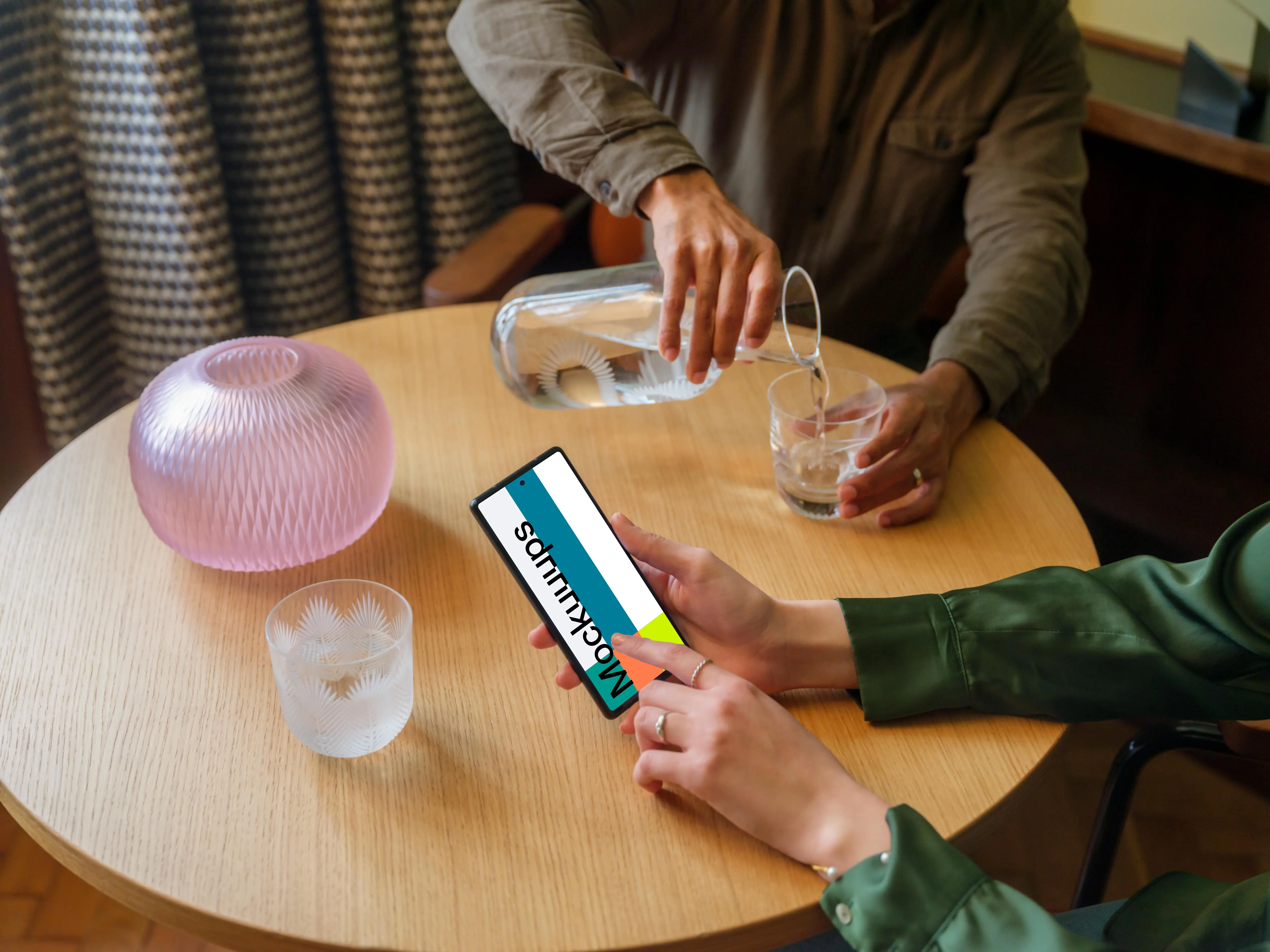 Lounge setting and woman working on a Google Pixel mockup