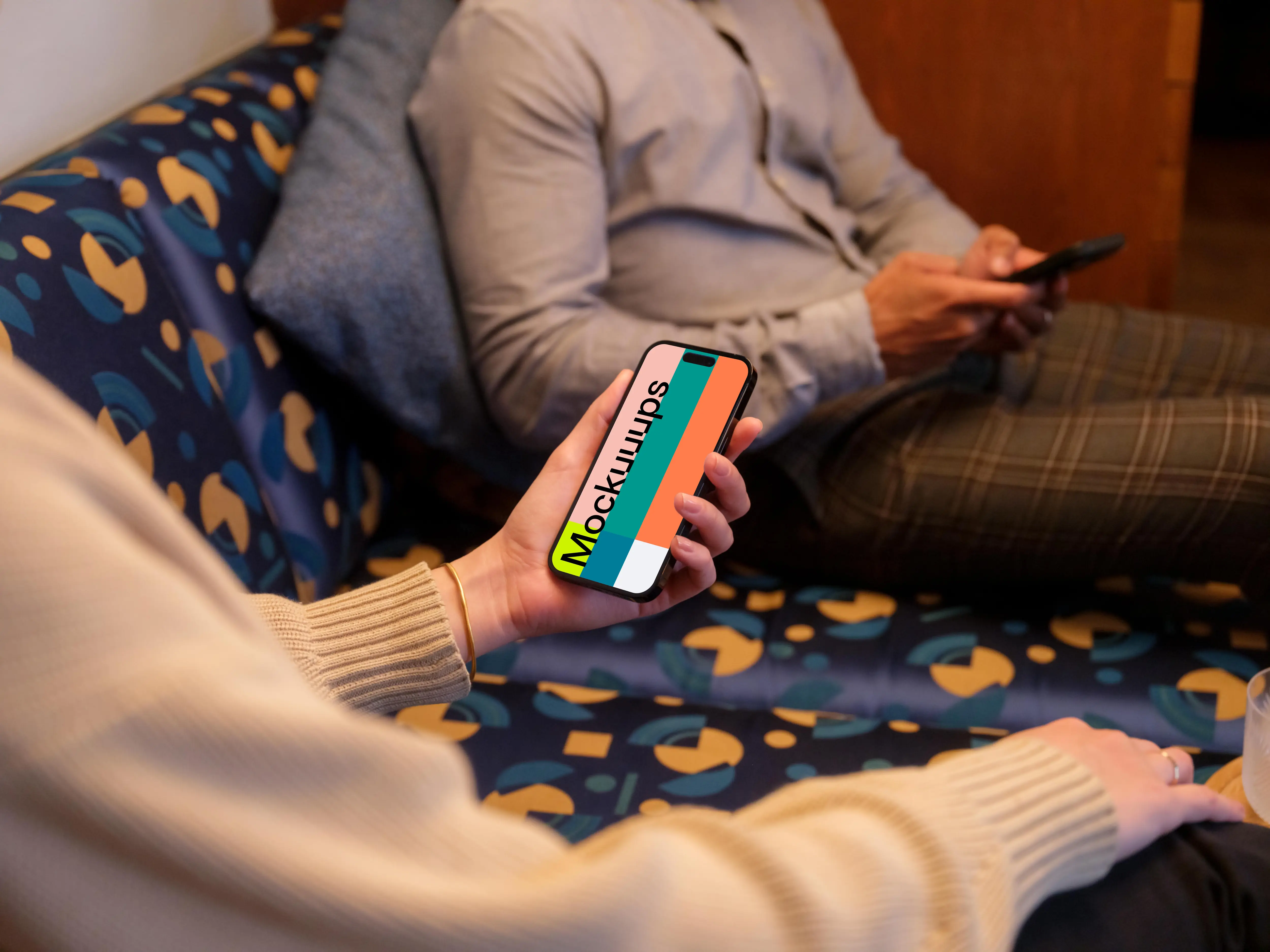 Lounge setting with co-workers and a iPhone mockup