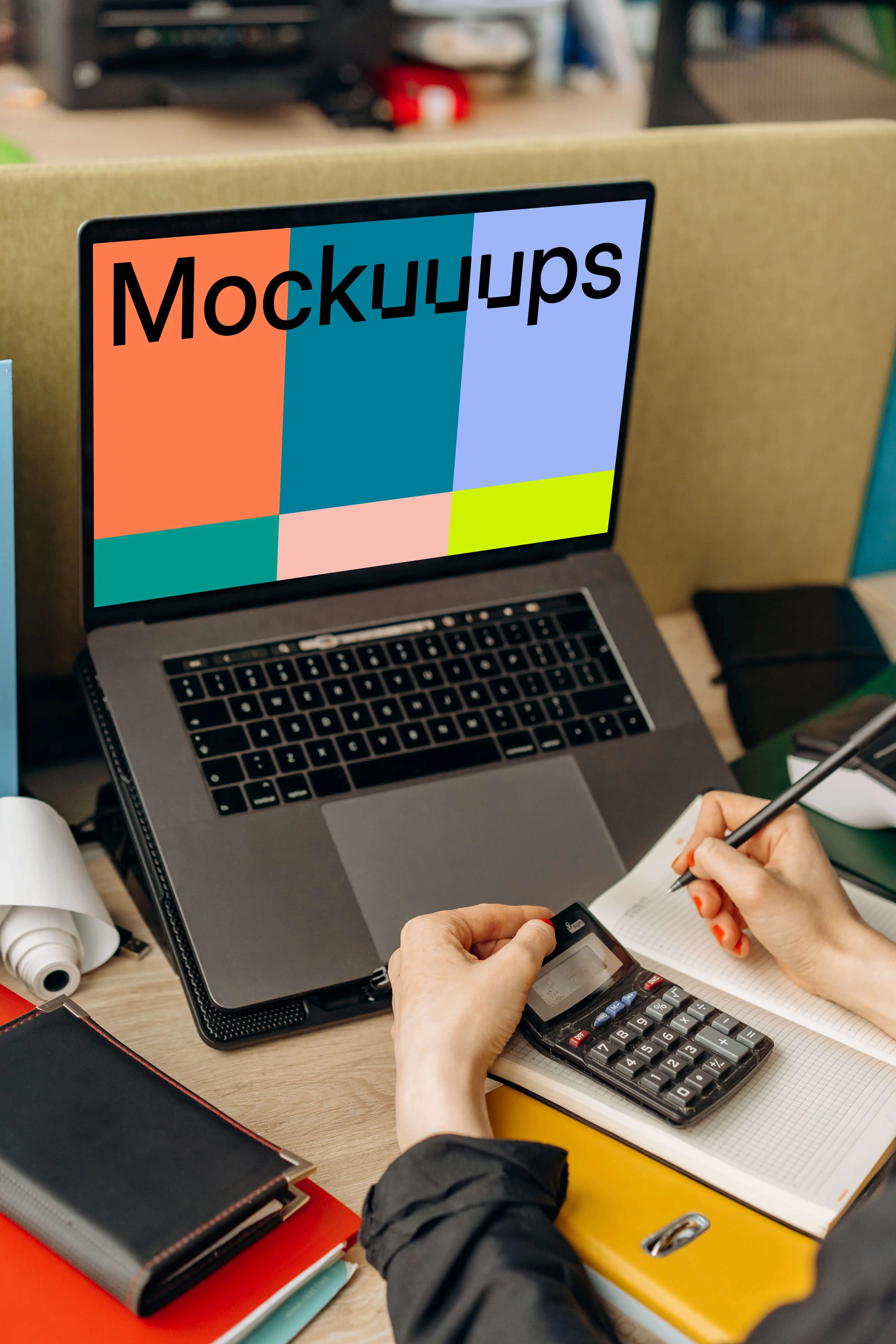 MacBook Air mockup and calculator in use by a man