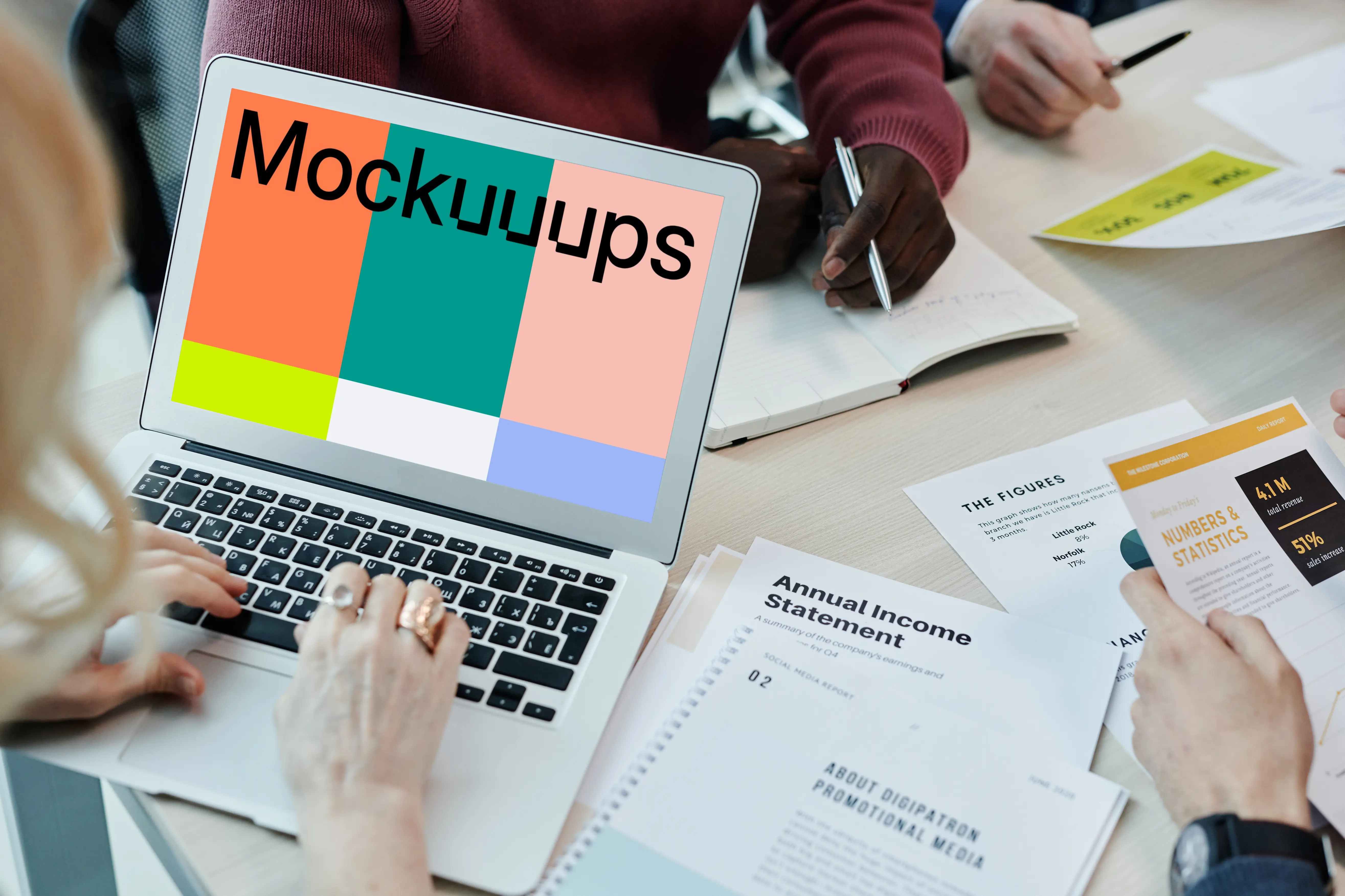 MacBook Air mockup in use at a team meeting