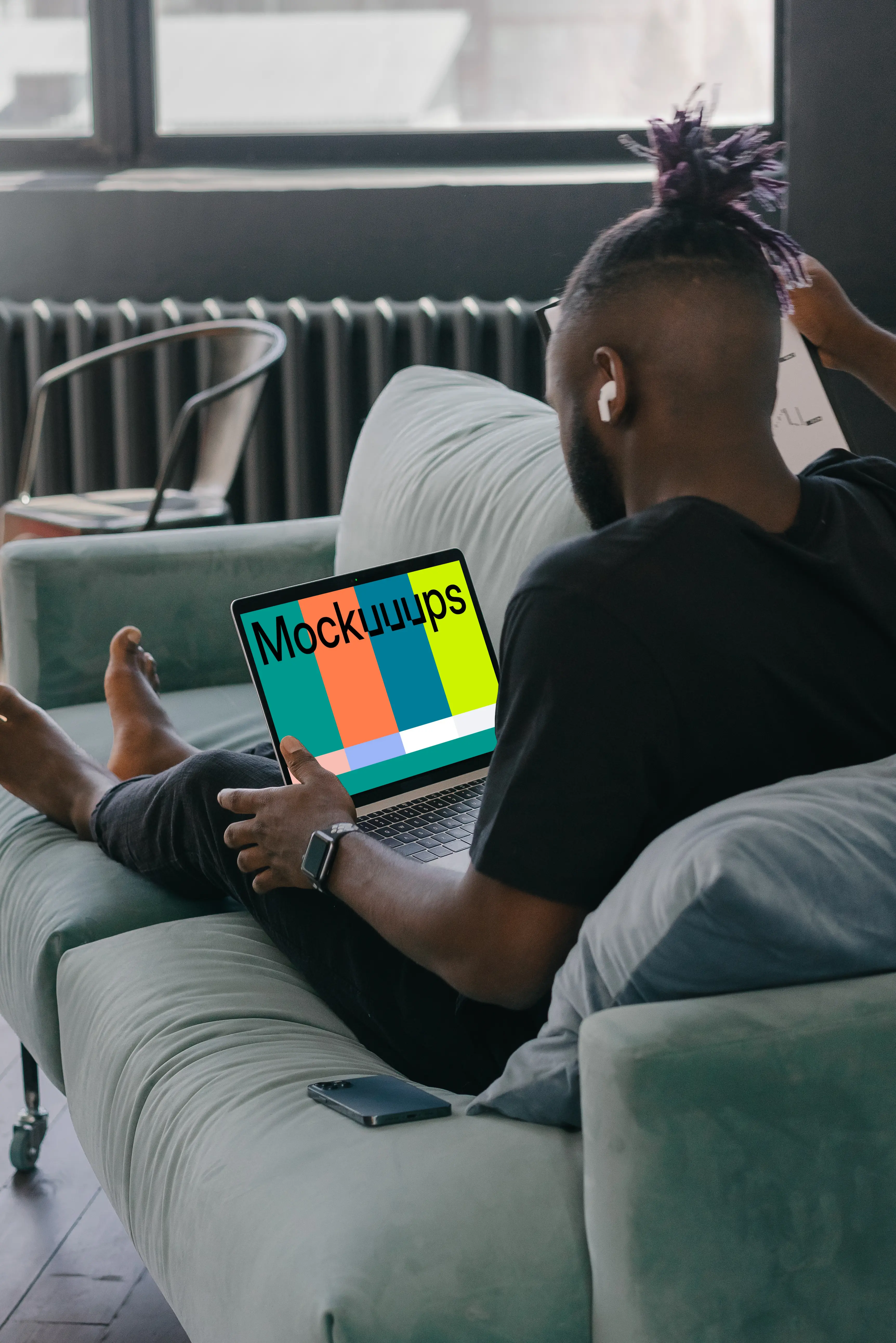 MacBook Air mockup in use by a man on a couch