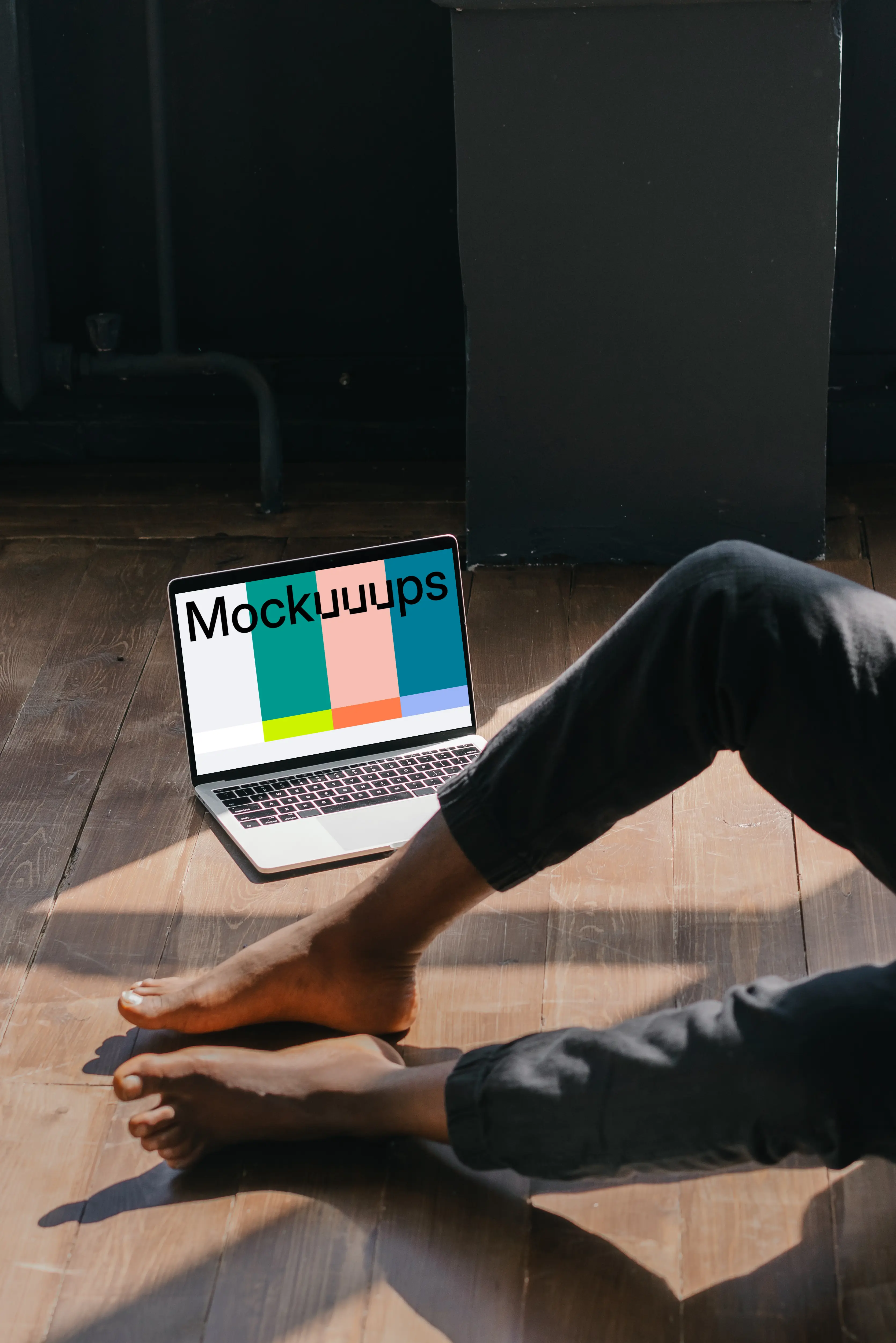 MacBook Air mockup placed on a wooden floor next to a user
