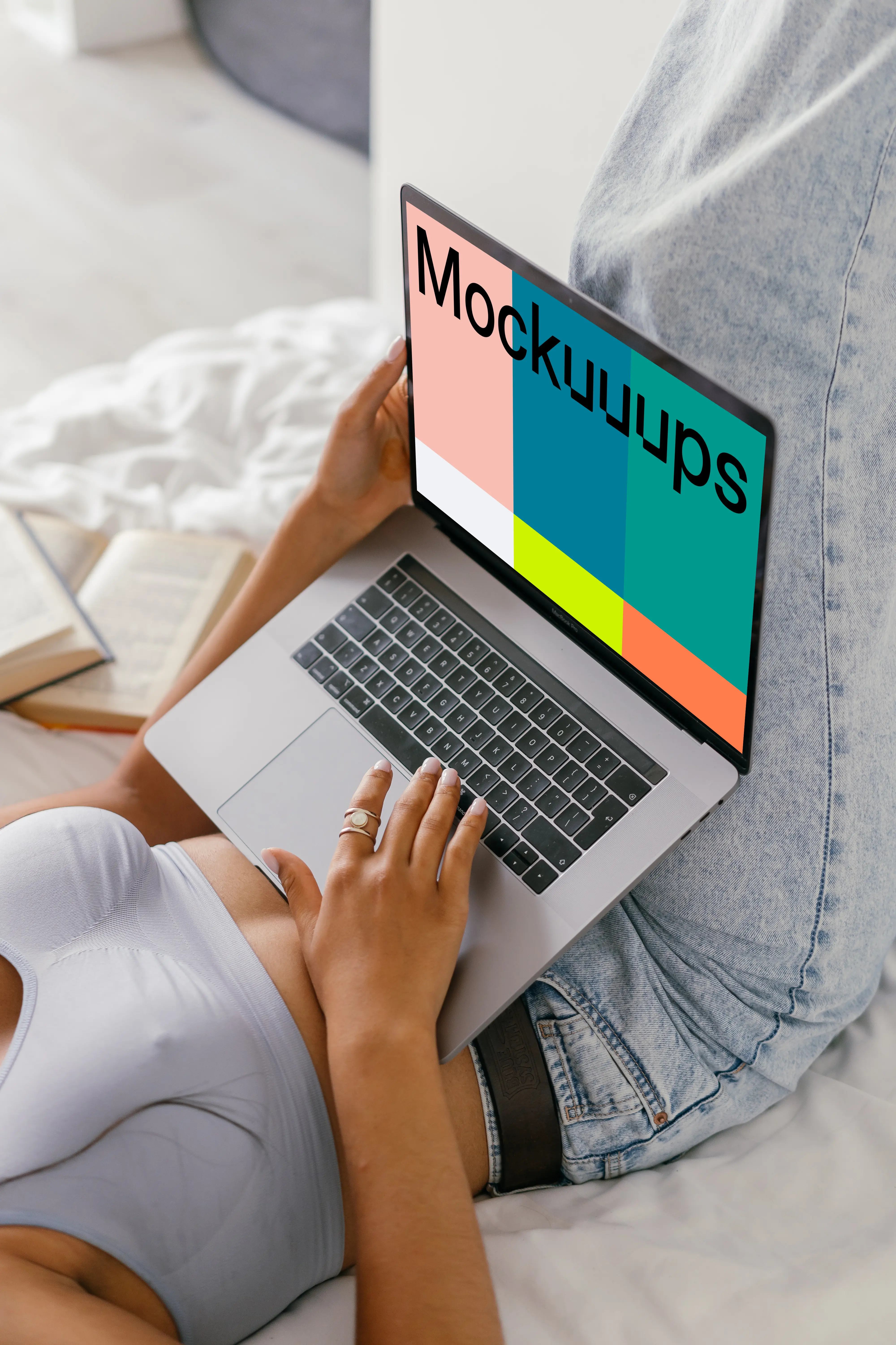 MacBook Air mockup used in bed by a lady