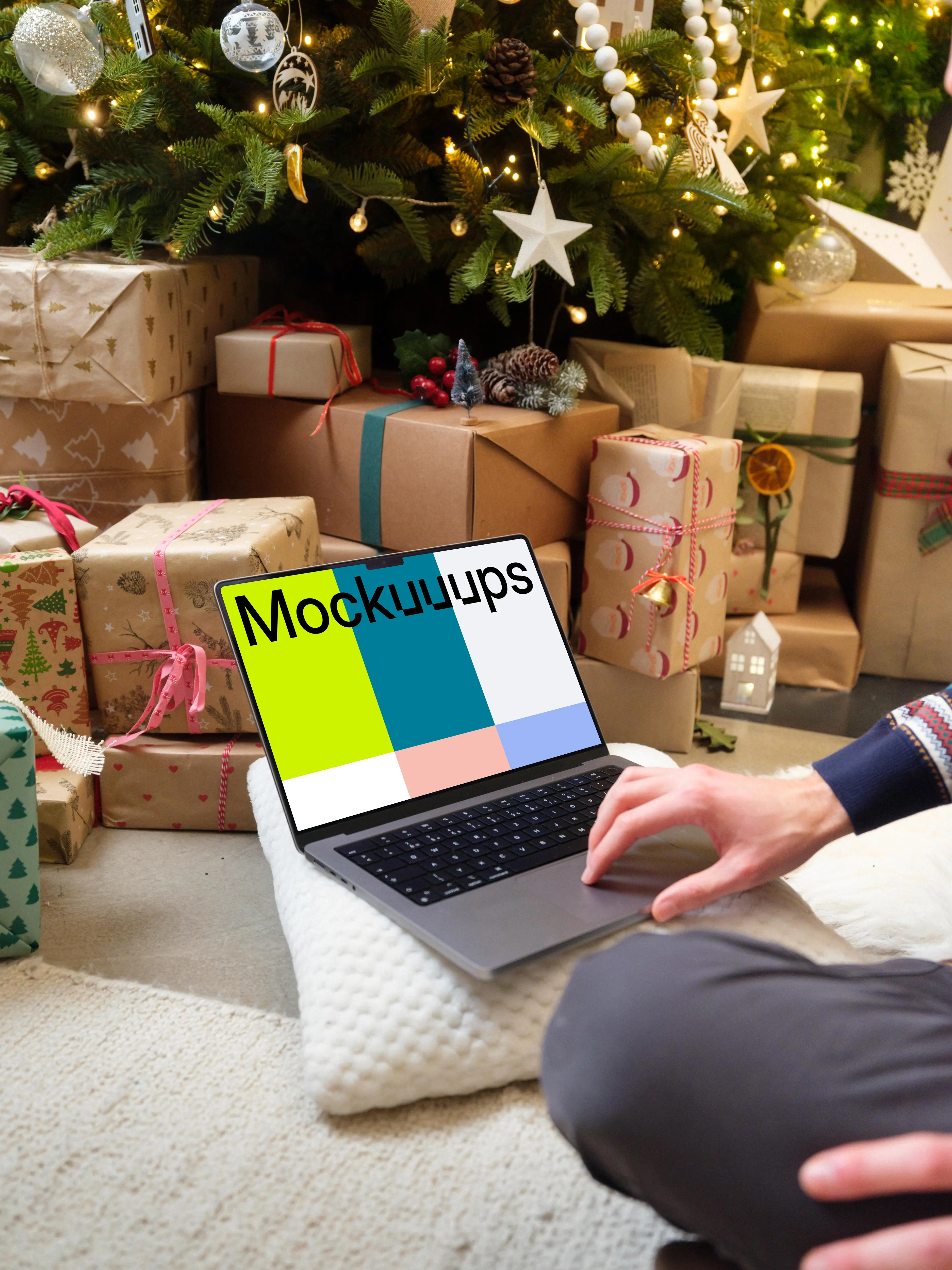 MacBook mockup next to the Christmas tree and gifts