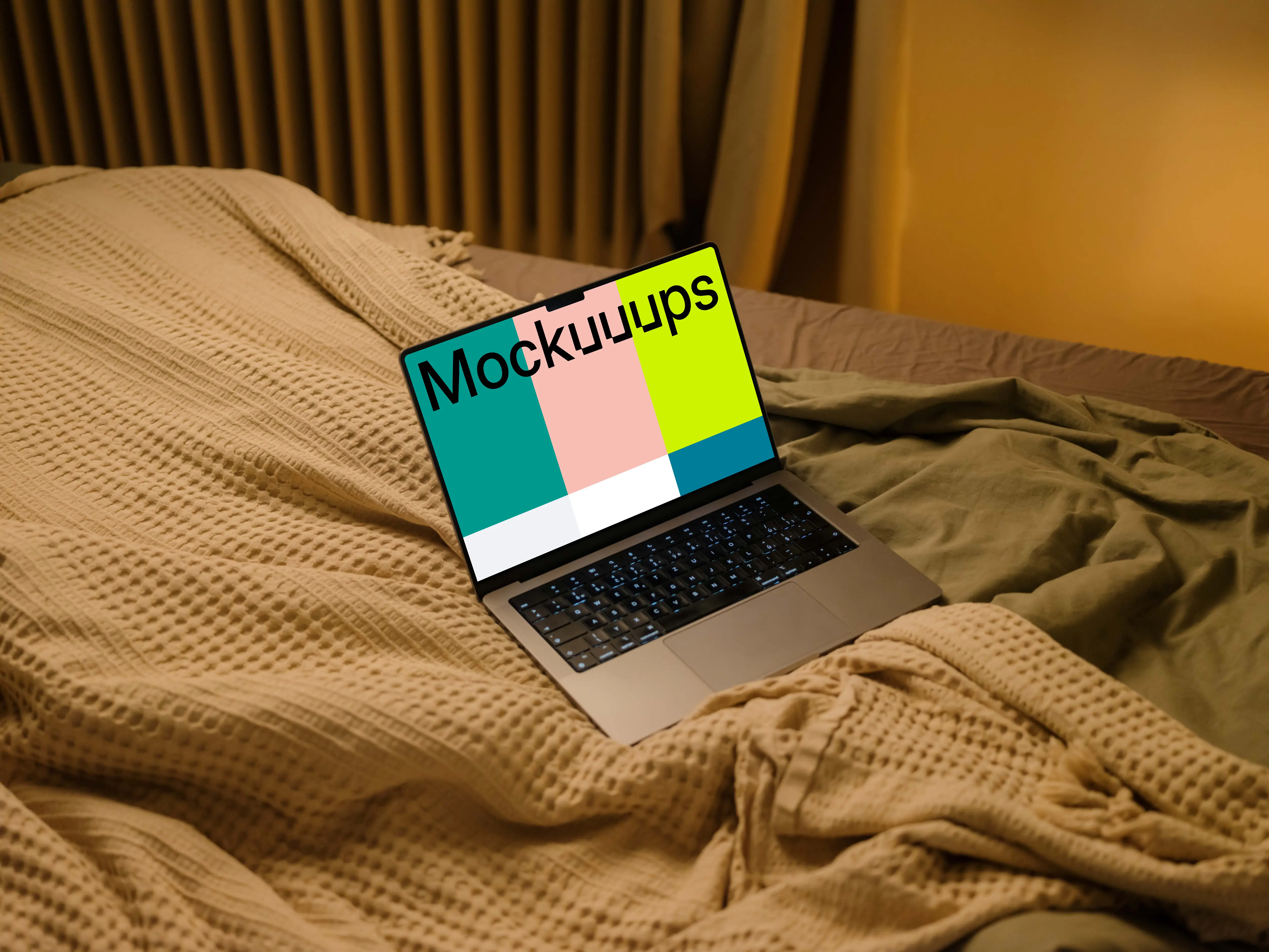 MacBook mockup on bed sheets