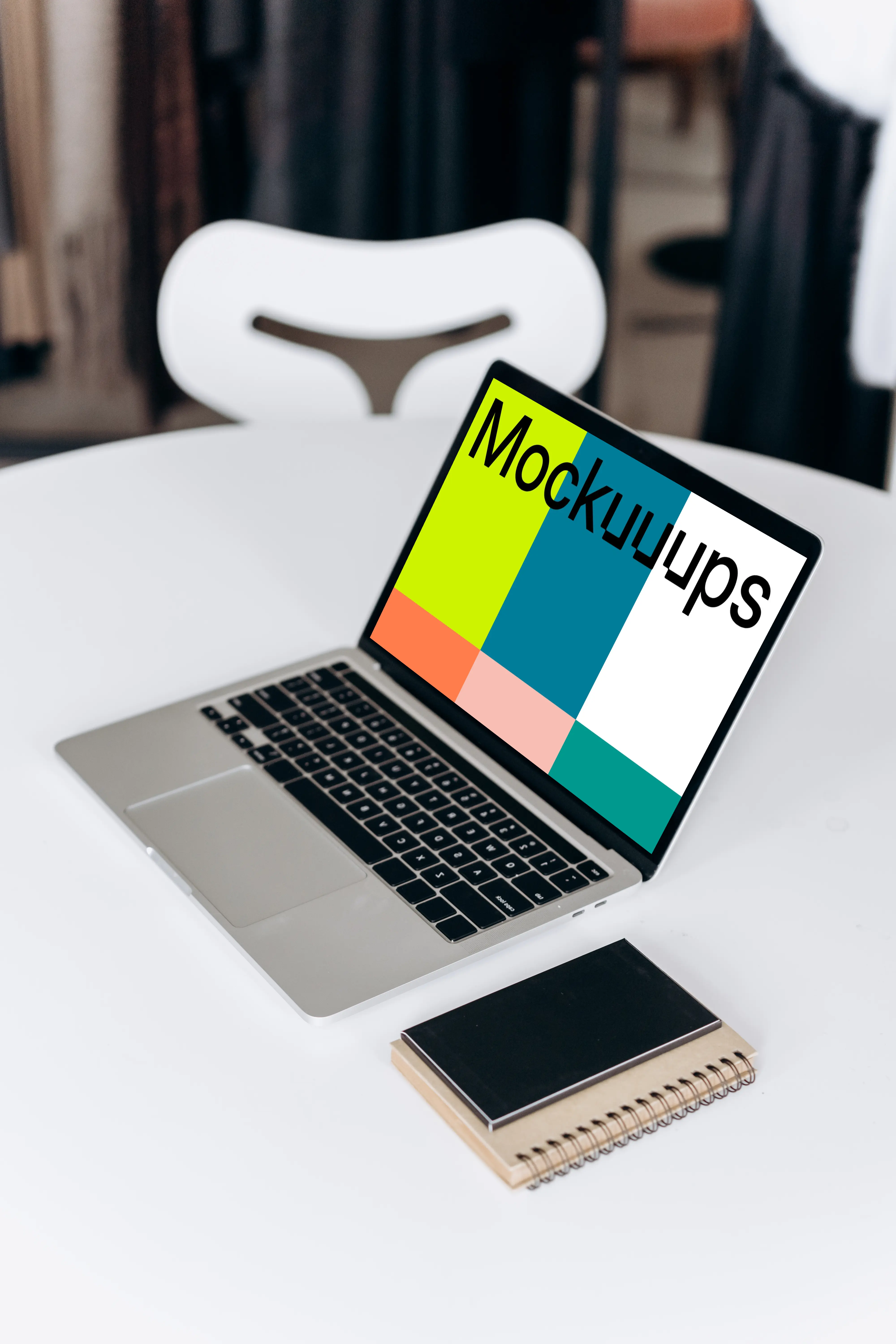 MacBook Pro mockup beside a phone and notepad