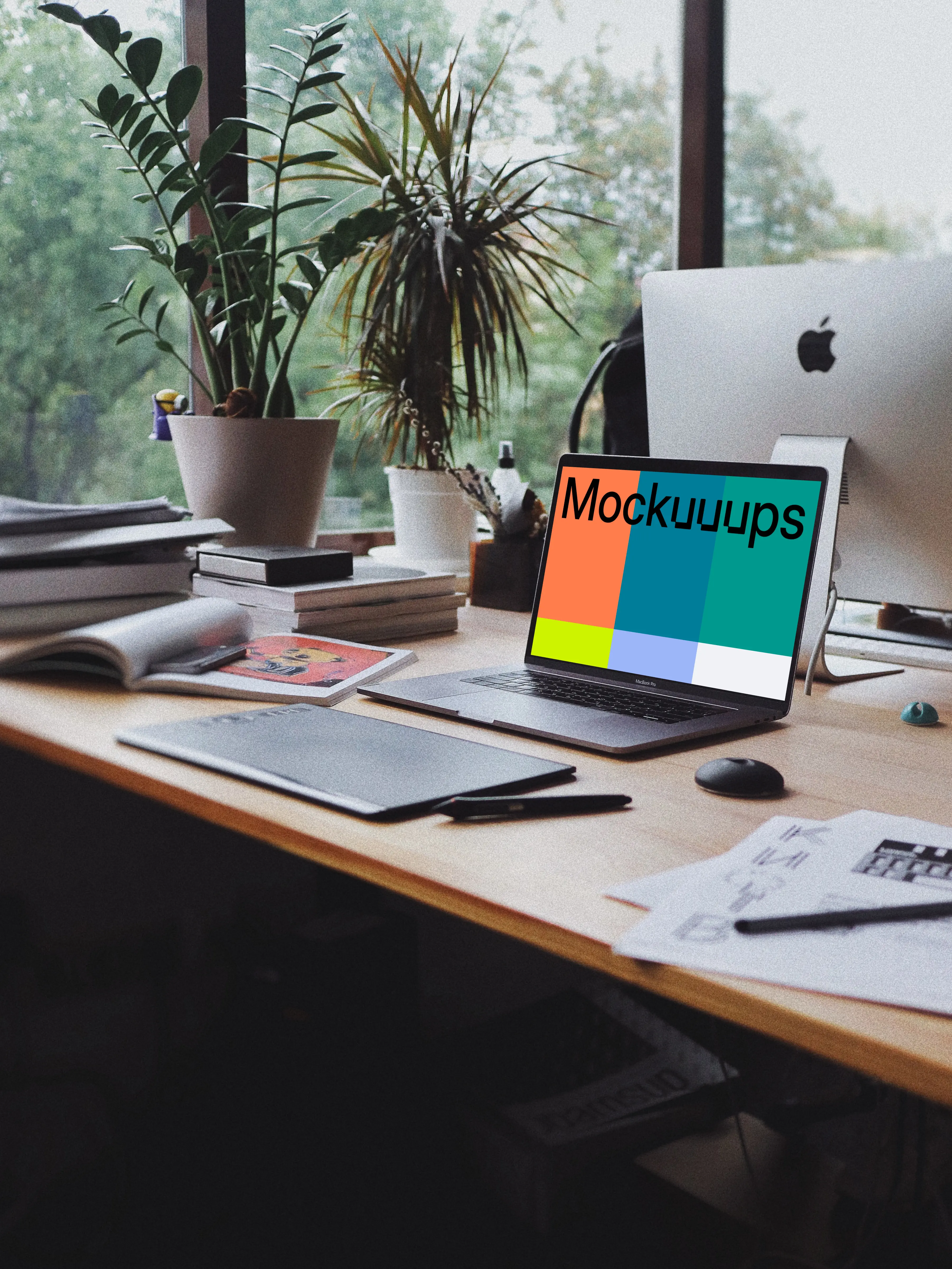 MacBook Pro mockup in front of a notepad