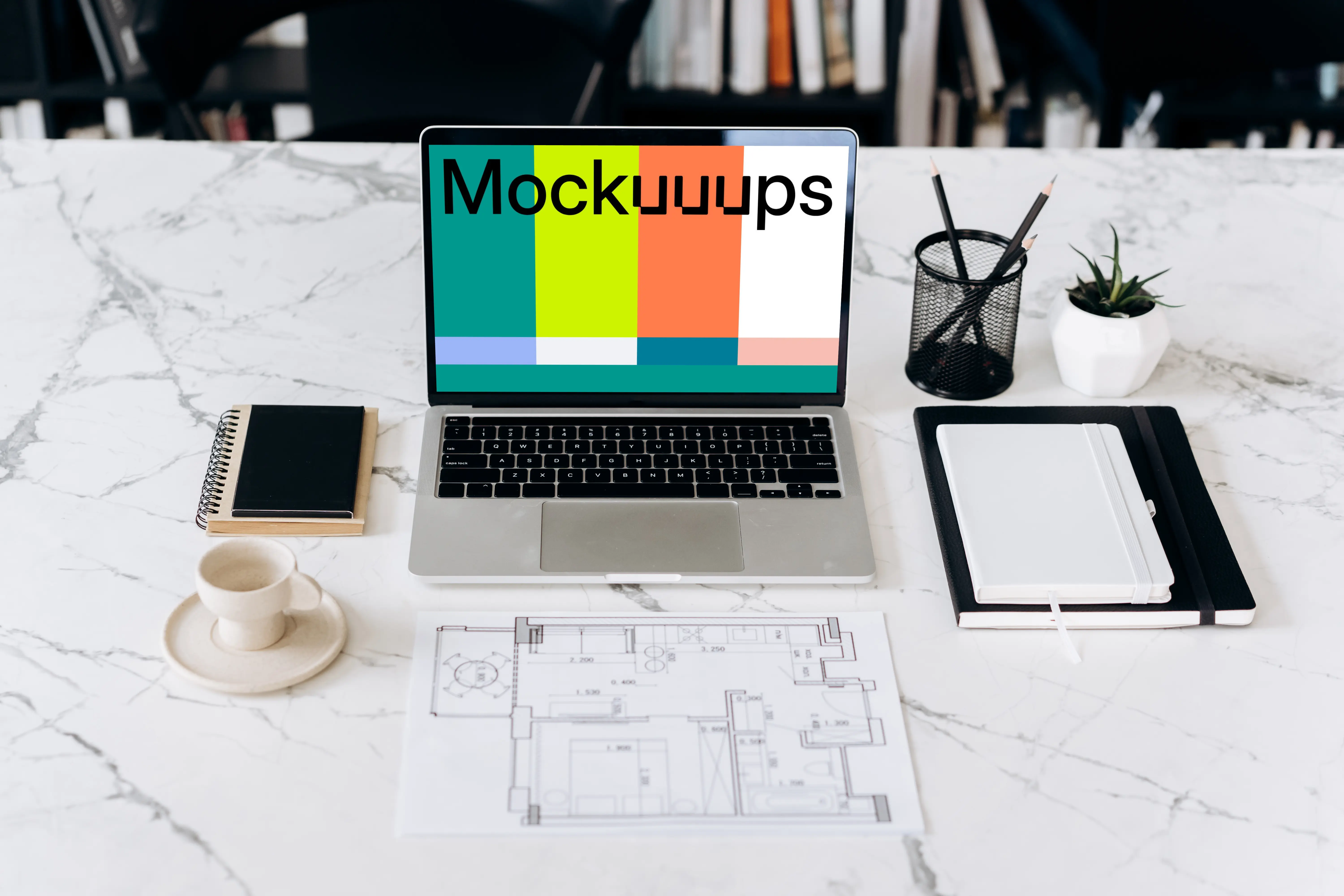 MacBook Pro mockup in front of an architectural plan