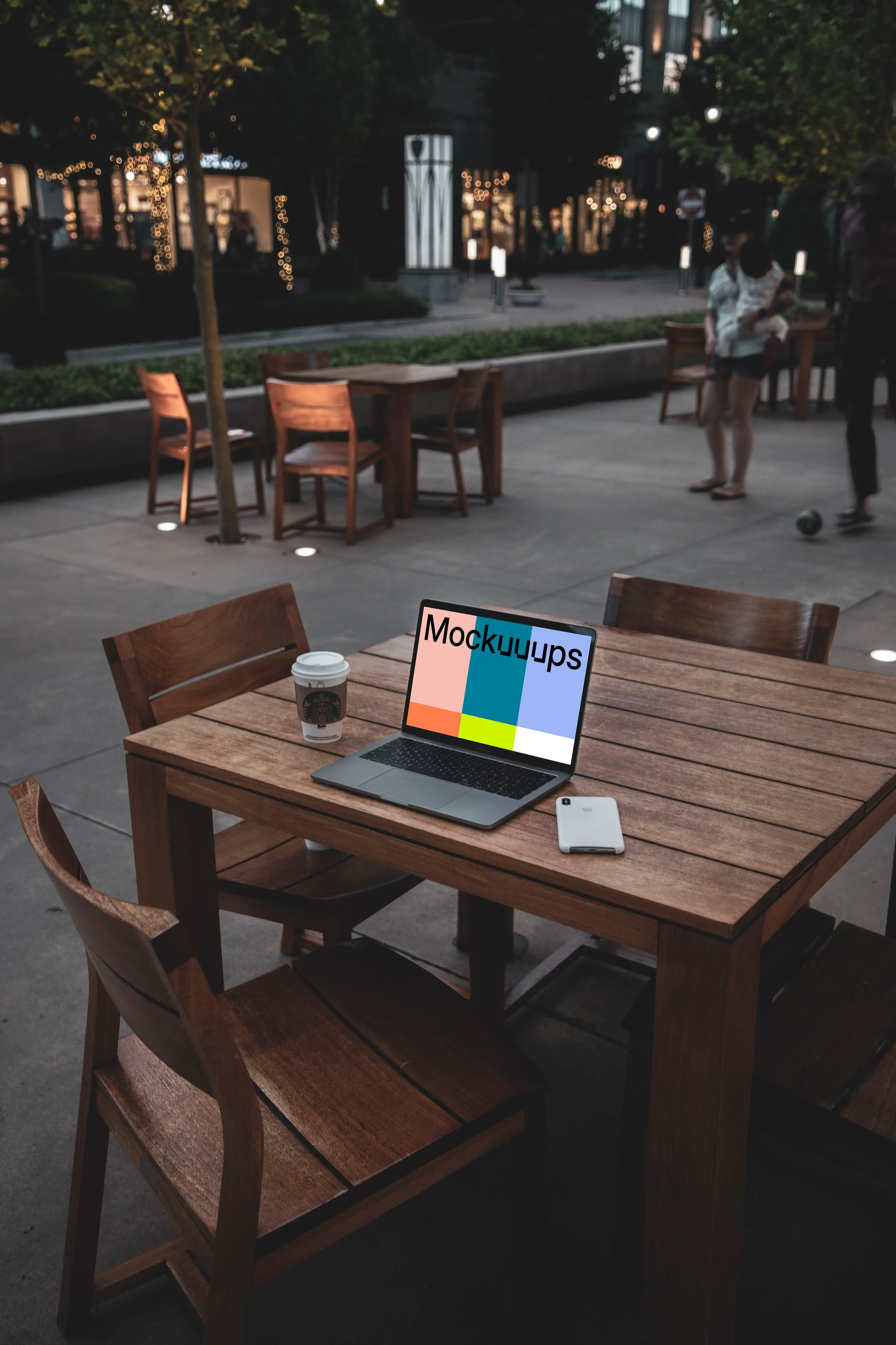 MacBook Pro mockup on wooden desk