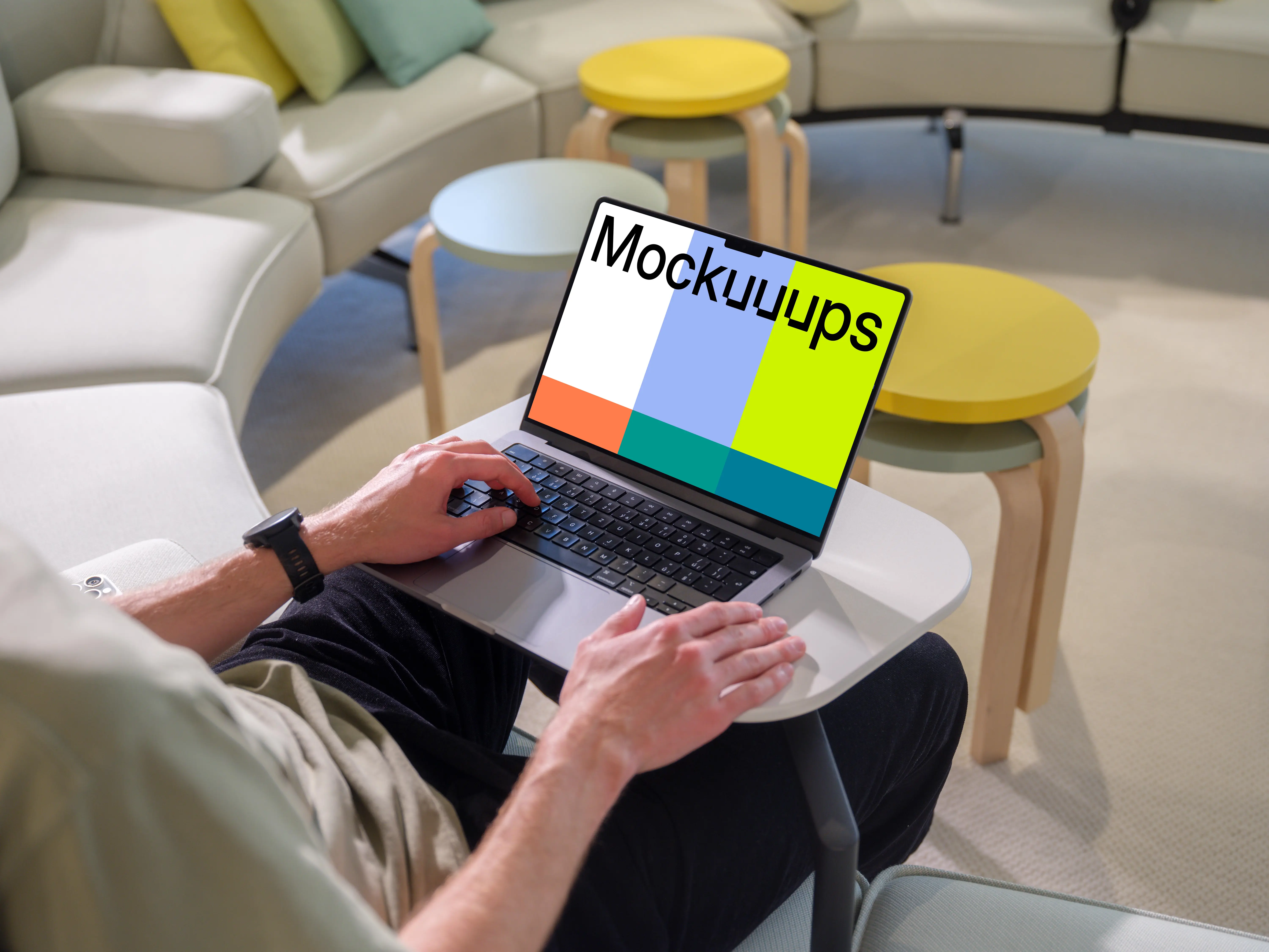 MacBook Pro mockup with a man in a casual workspace