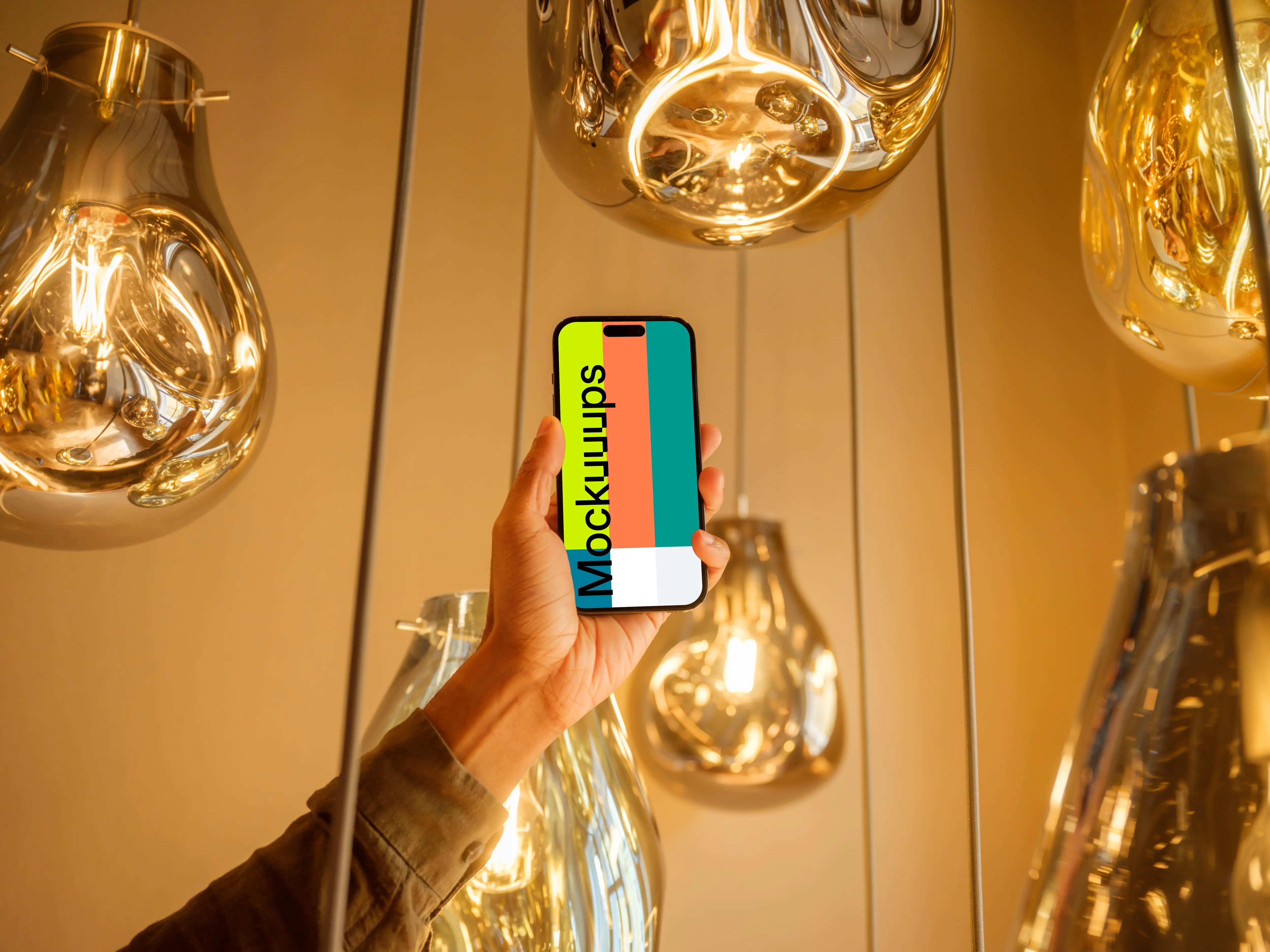 Male hand holding a iPhone mockup in the lounge