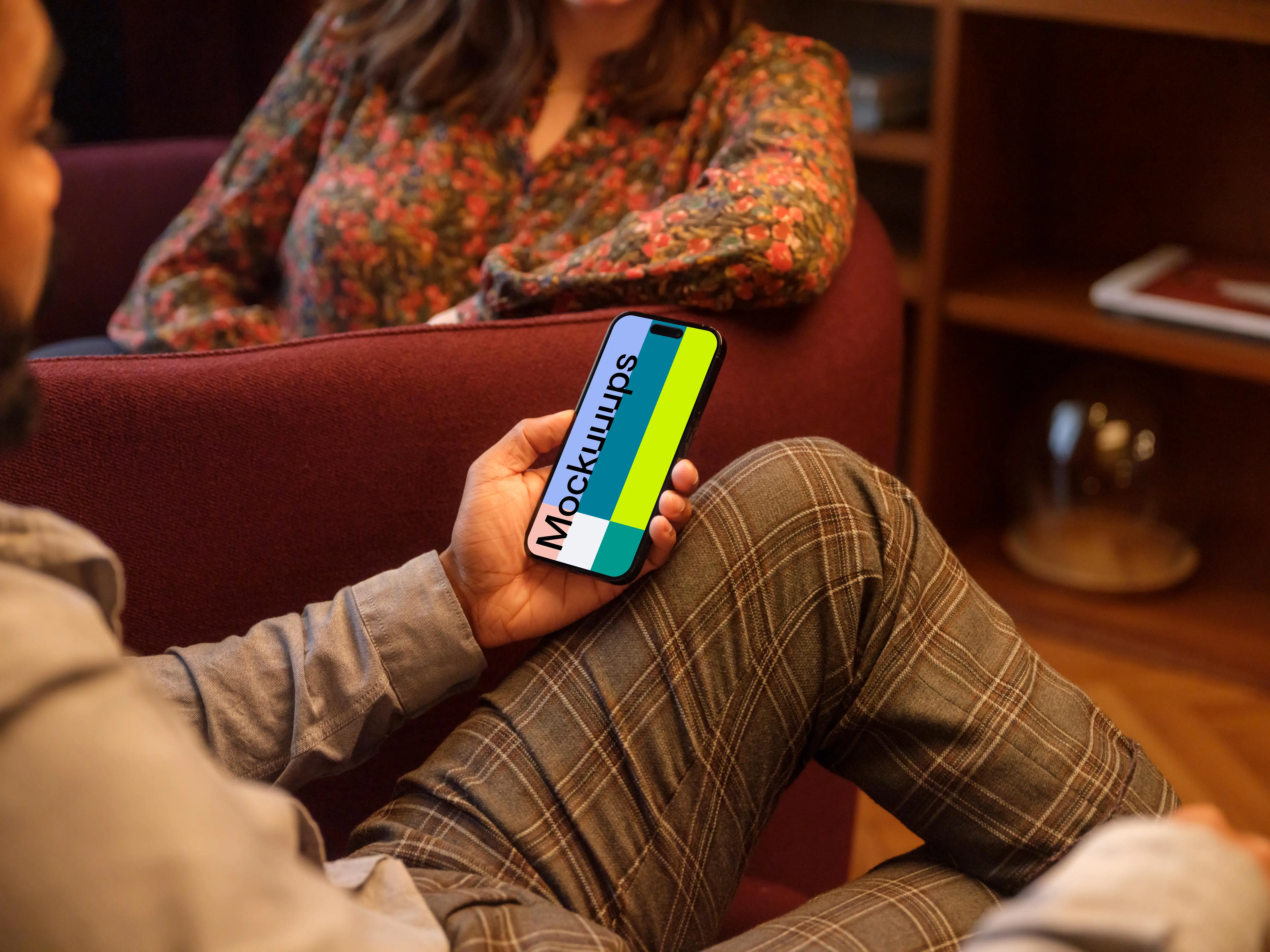 Male hand holding a phone in lounge