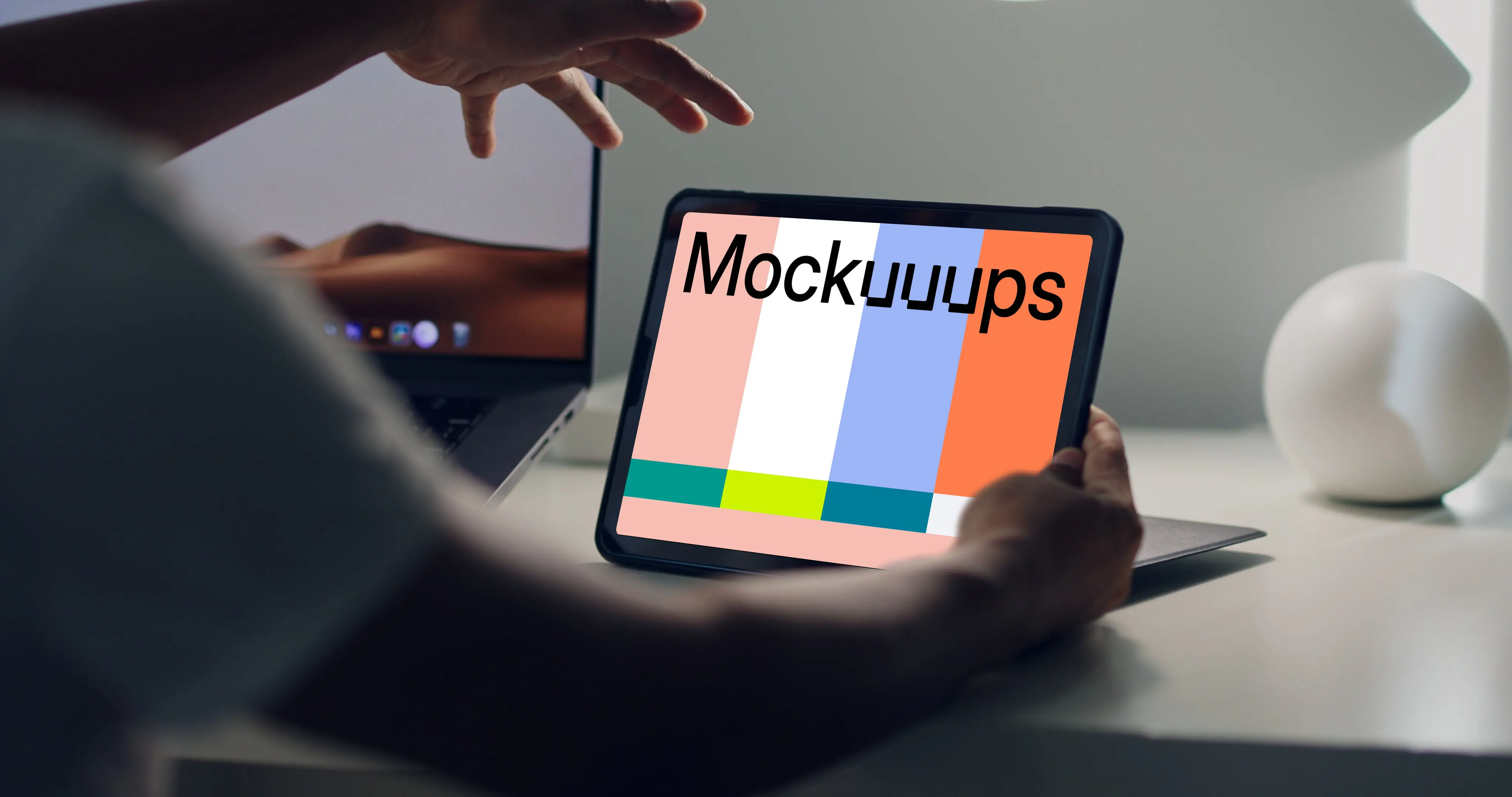 Male hands holding an iPad mockup stood on a table