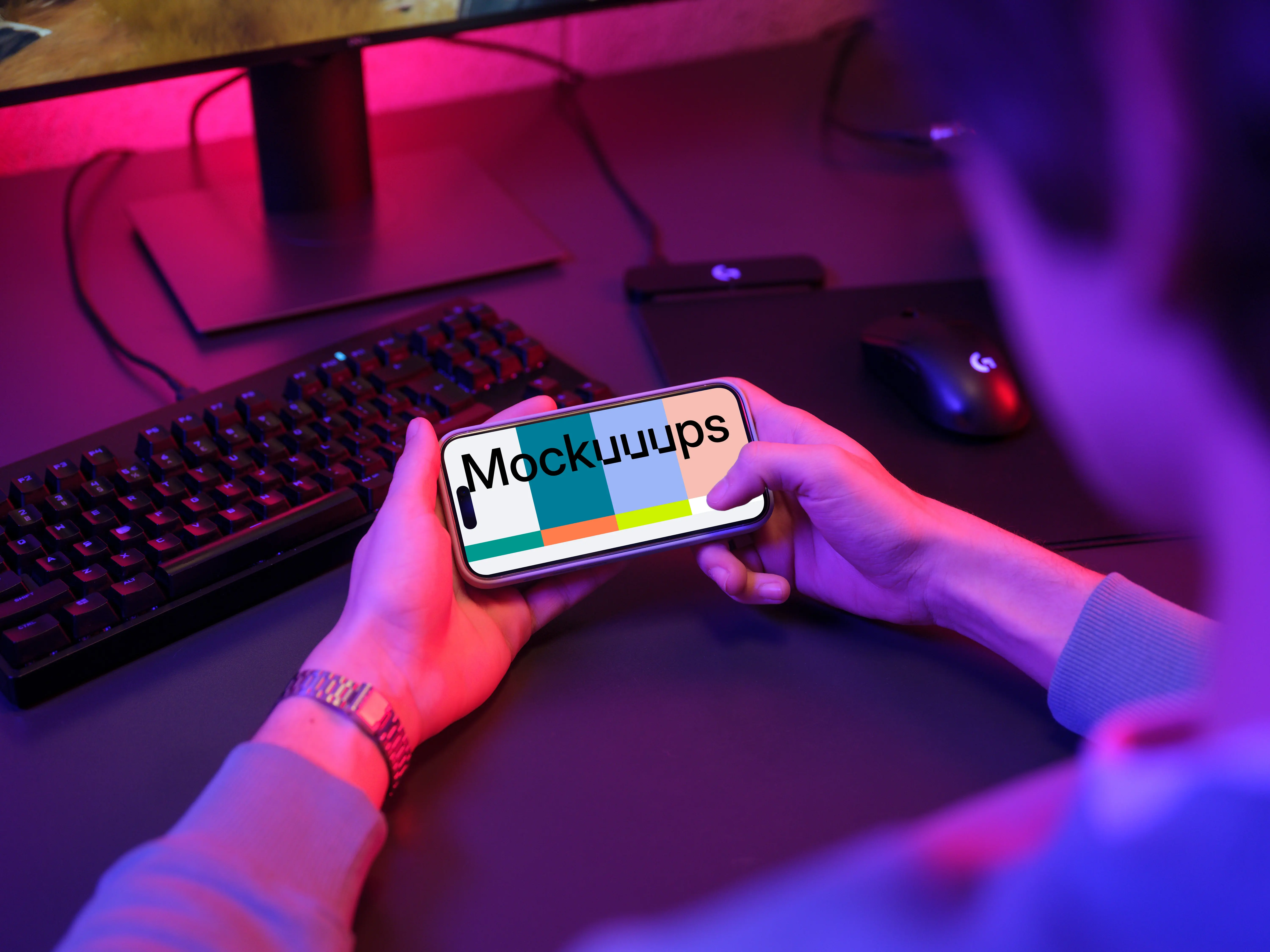 Male hands holding an iPhone mockup in gaming room