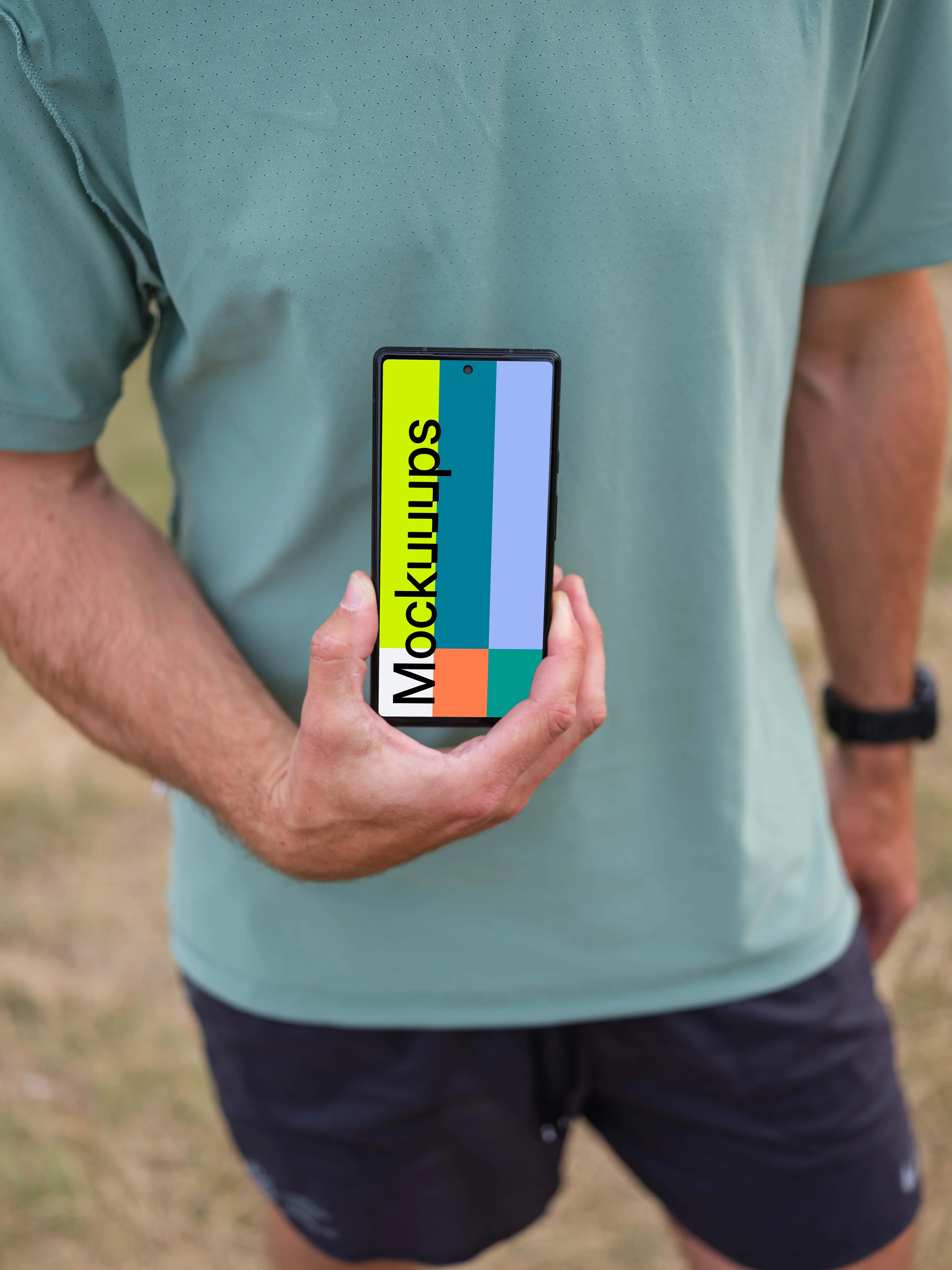 Male trail runner holding a smartphone mockup