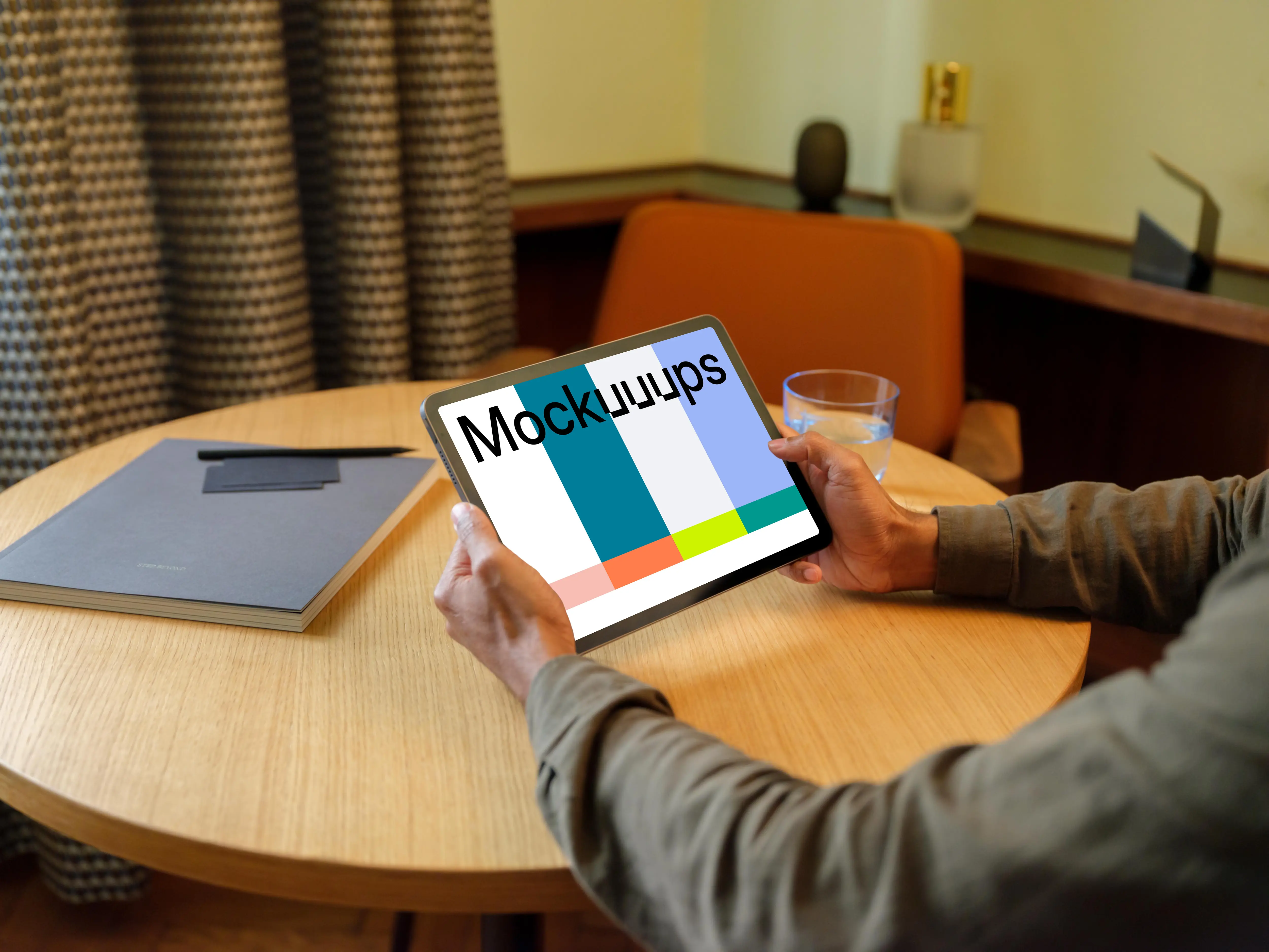 Man holding a iPad mockup in the lounge
