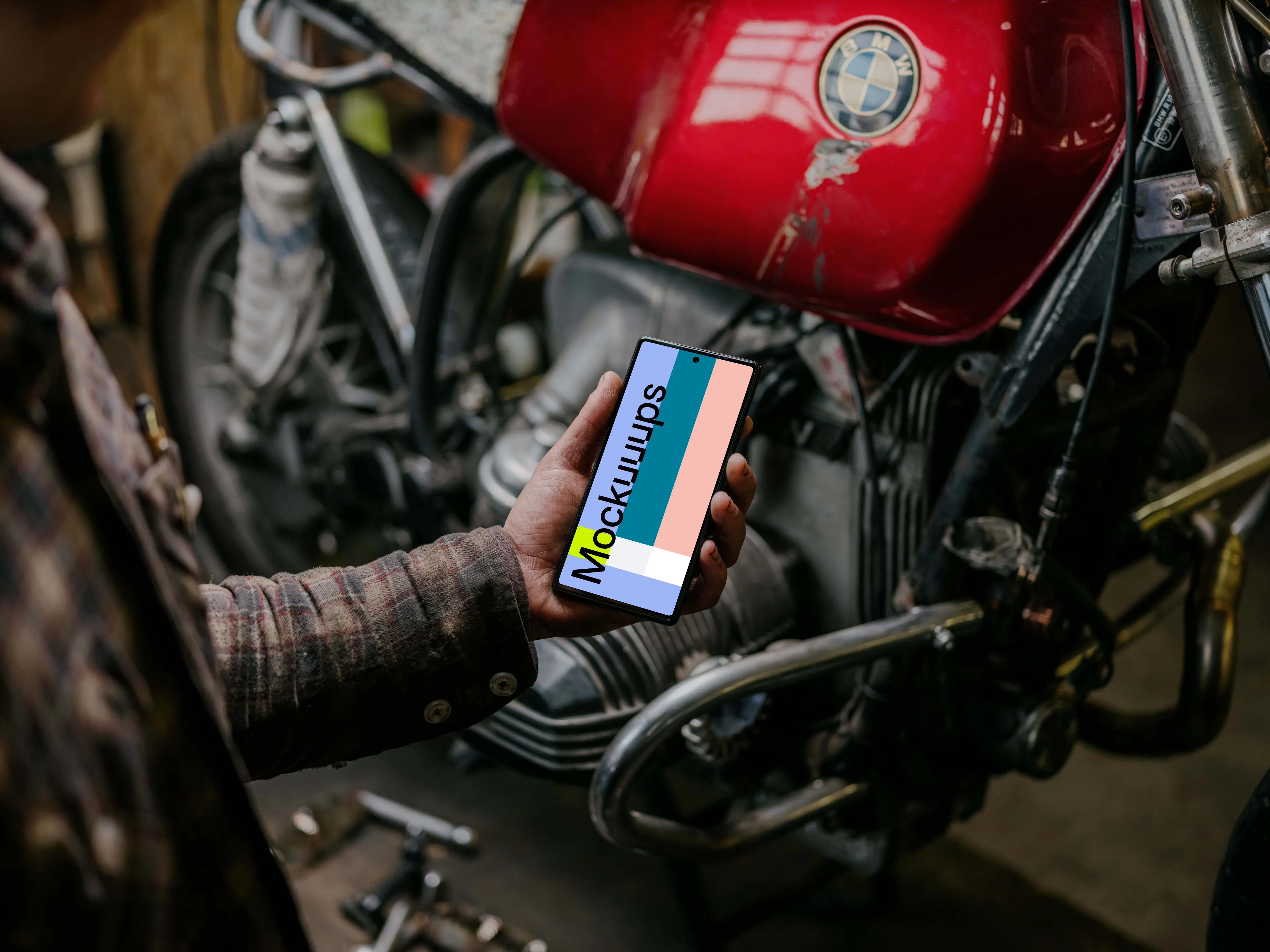 Man holding a Pixel 6 mockup beside a motorcycle