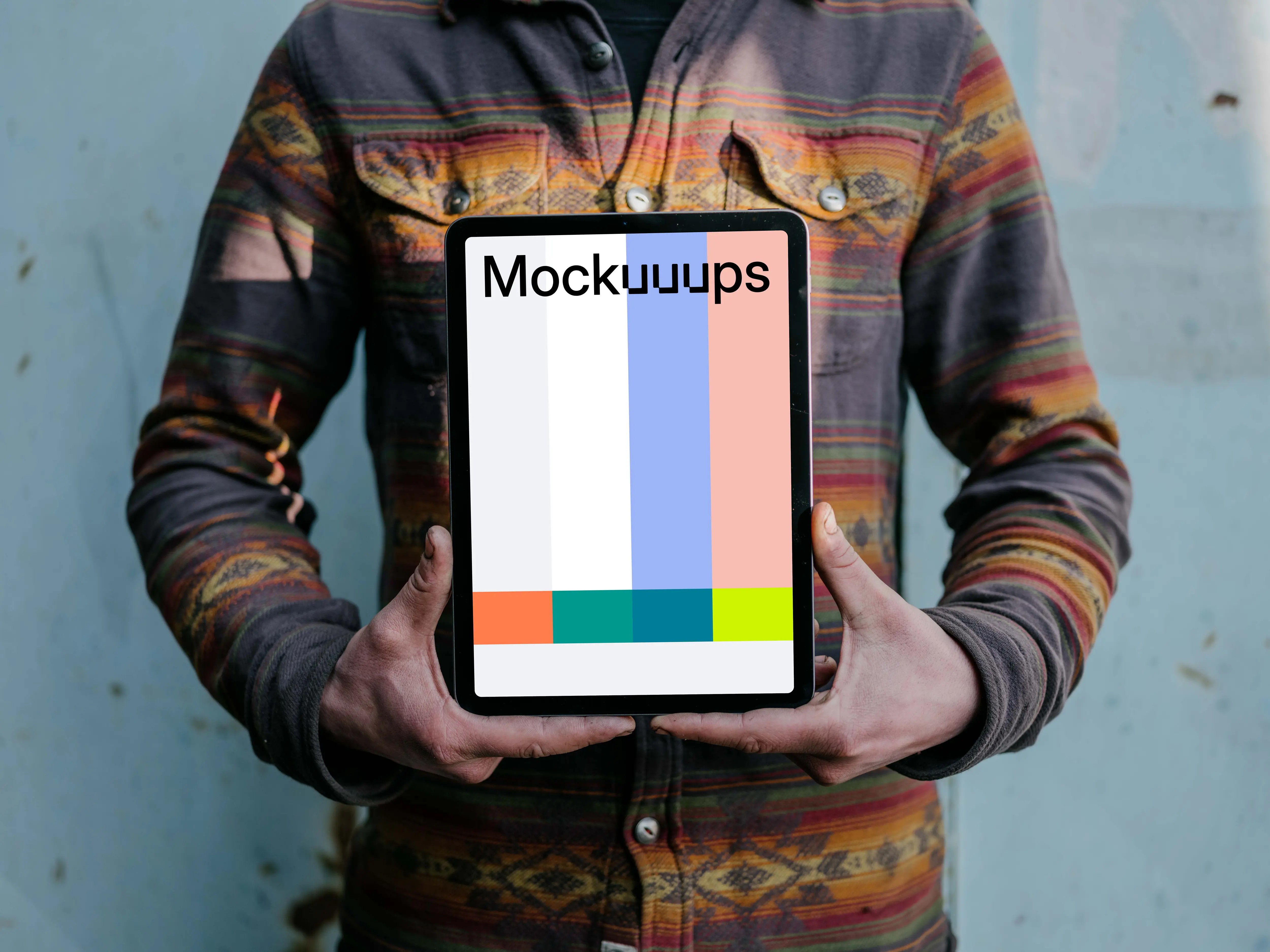 Man holding an iPad Air mockup in potrait mode