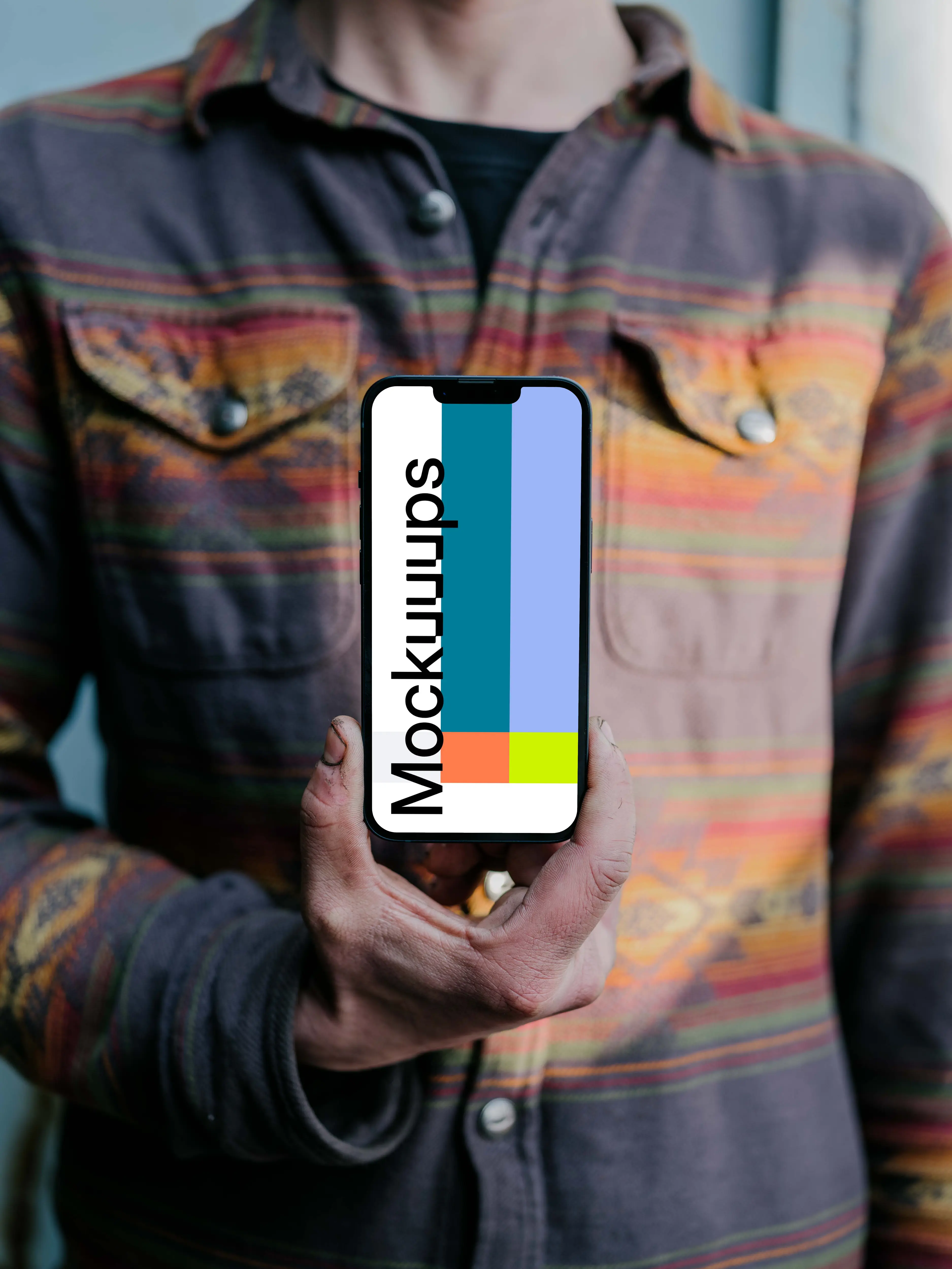 Man holding an iPhone 13 Pro mockup to his chest