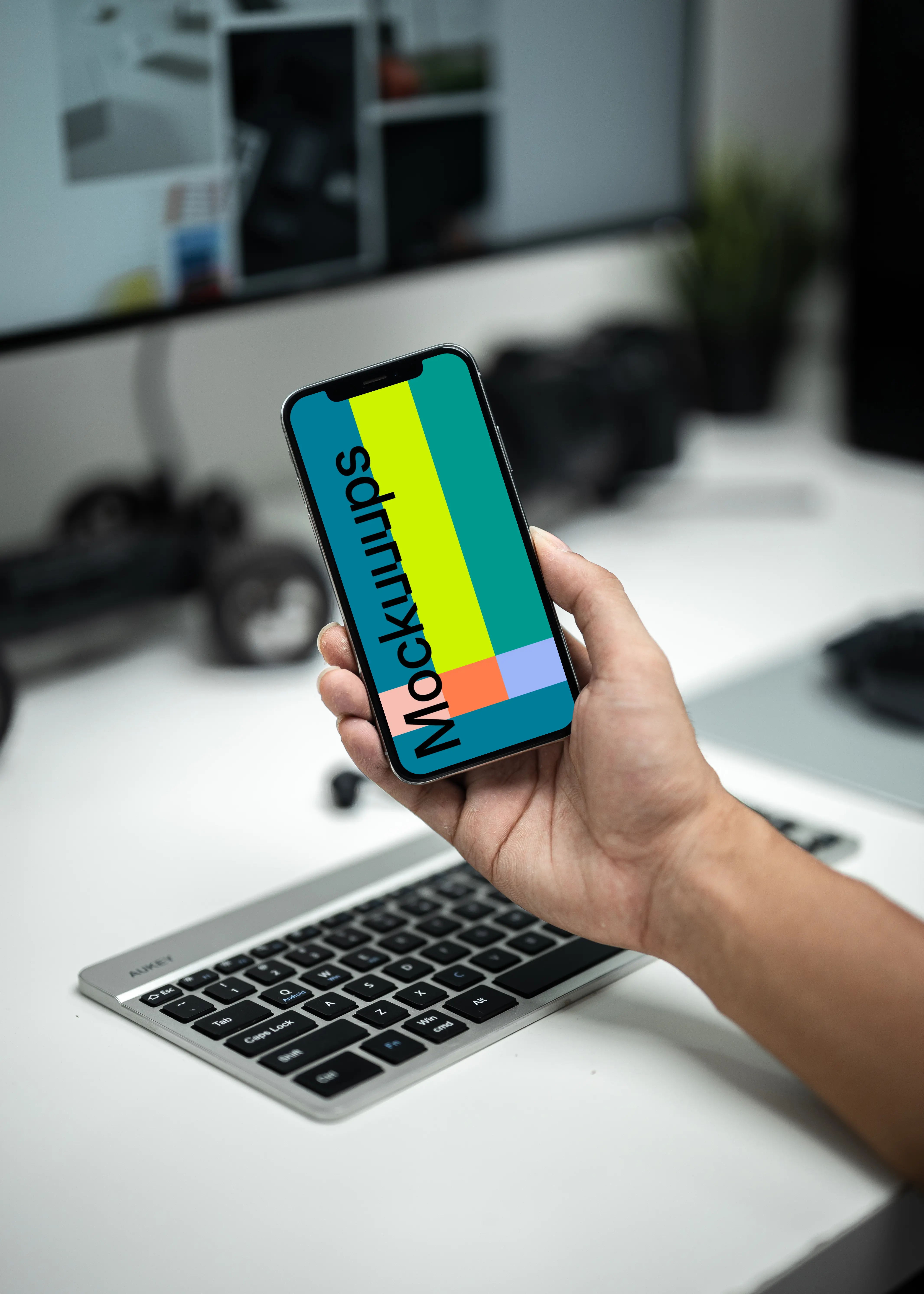 Man holding up an iPhone 12 mockup