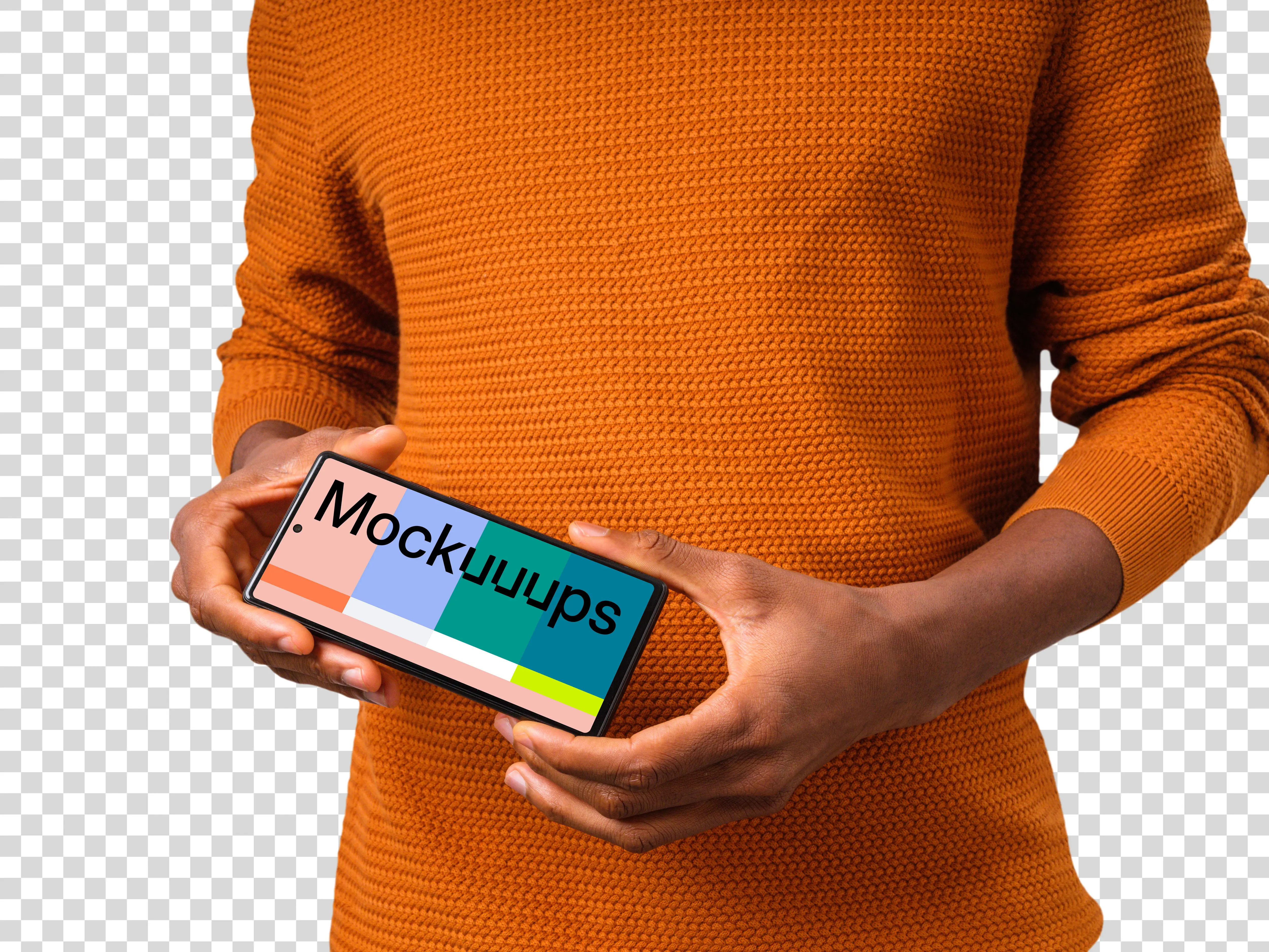 Man in orange sweater holding Google Pixel mockup in landscape