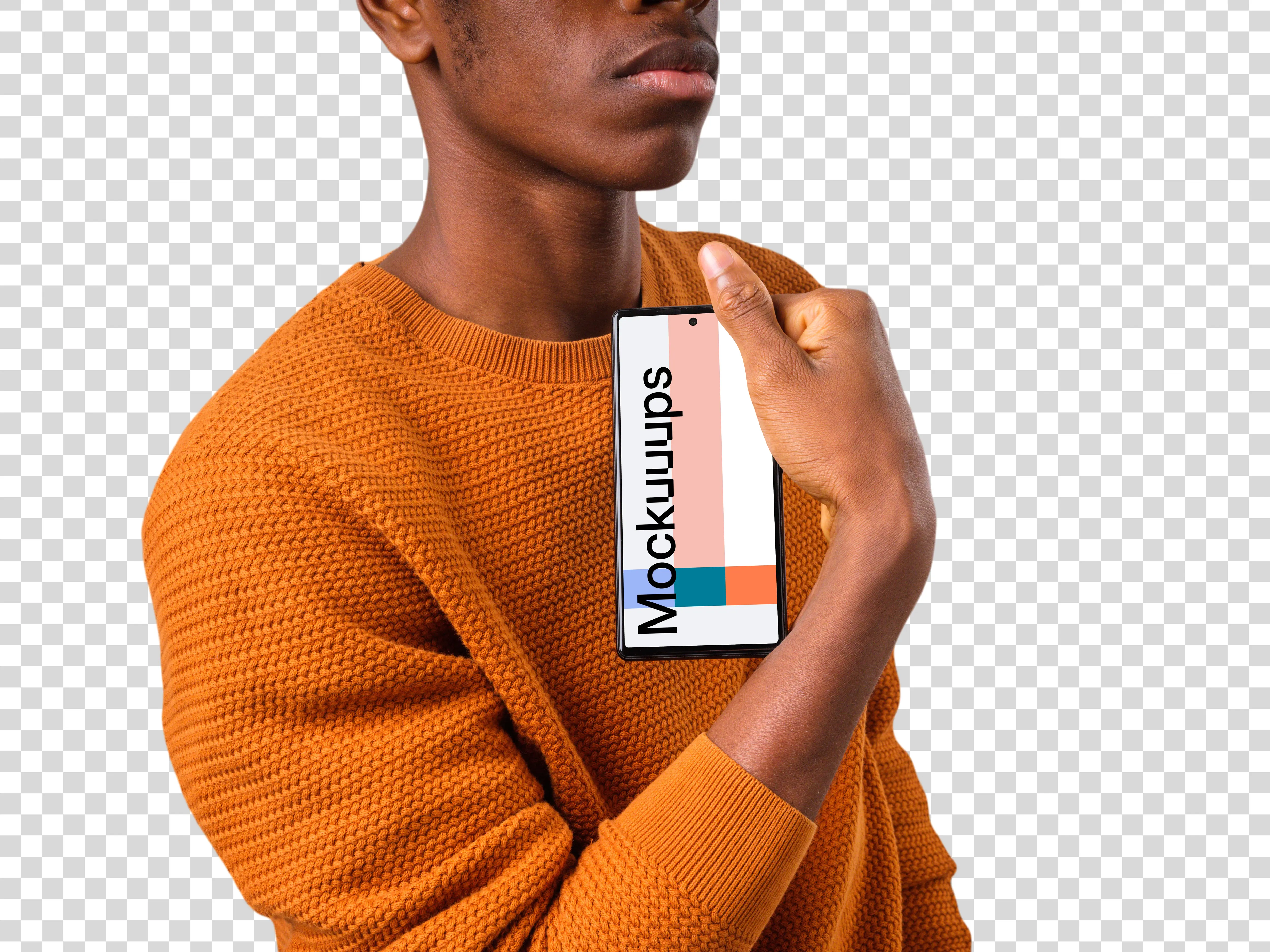 Man in orange sweater holding Google Pixel mockup in one hand