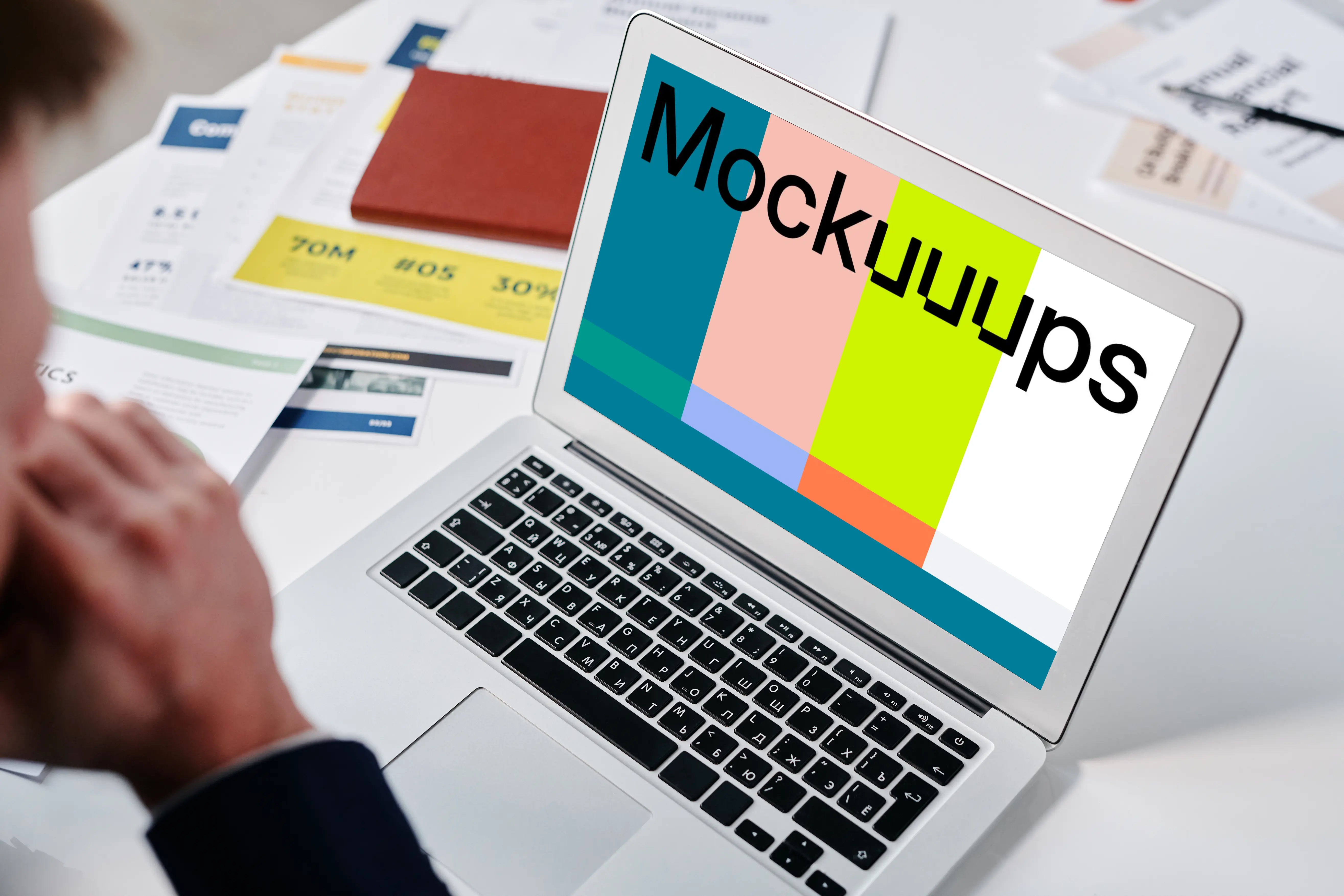 Man sitting at a desk using a MacBook Air mockup