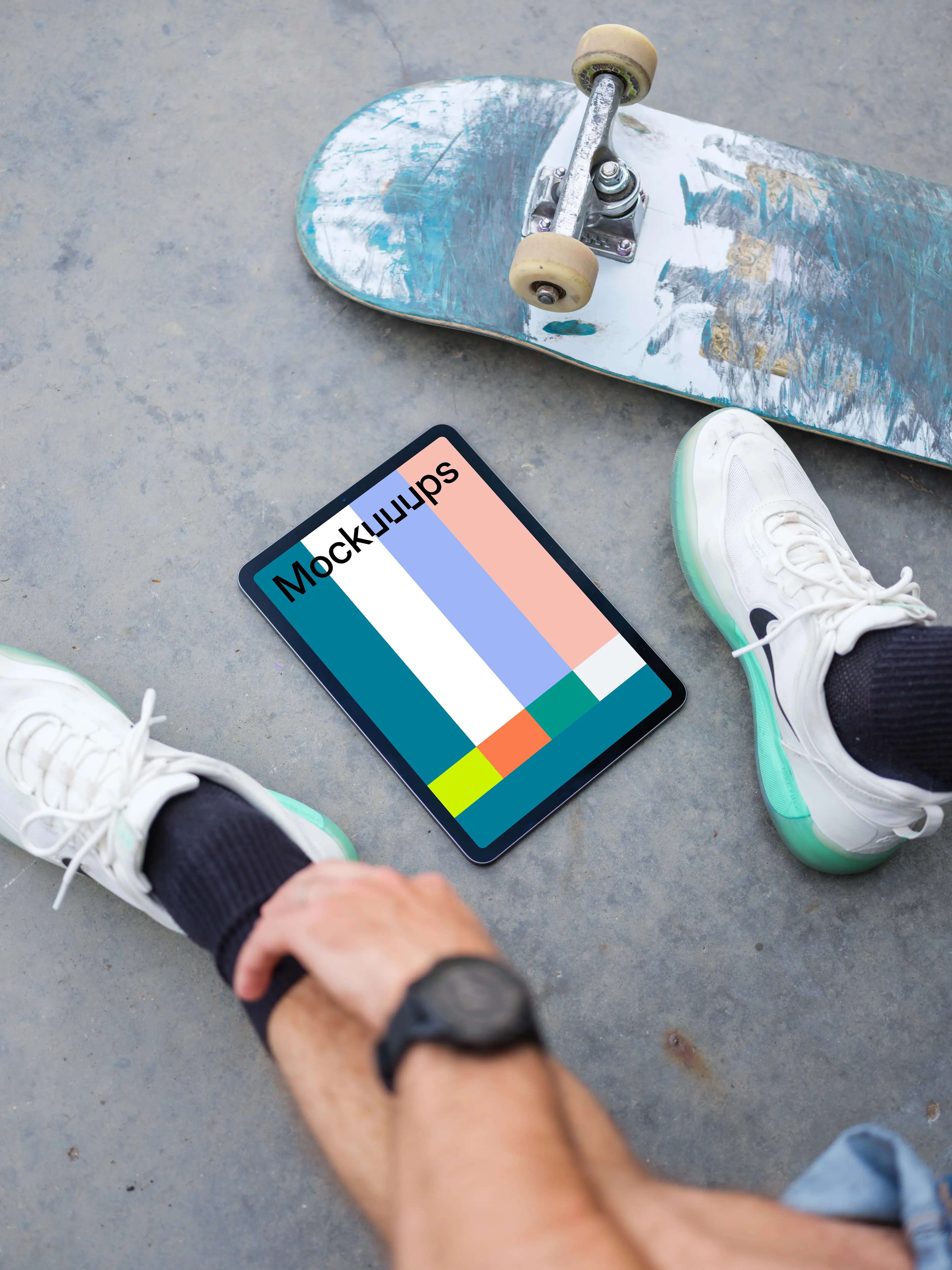 Man sitting next to an iPad Air mockup