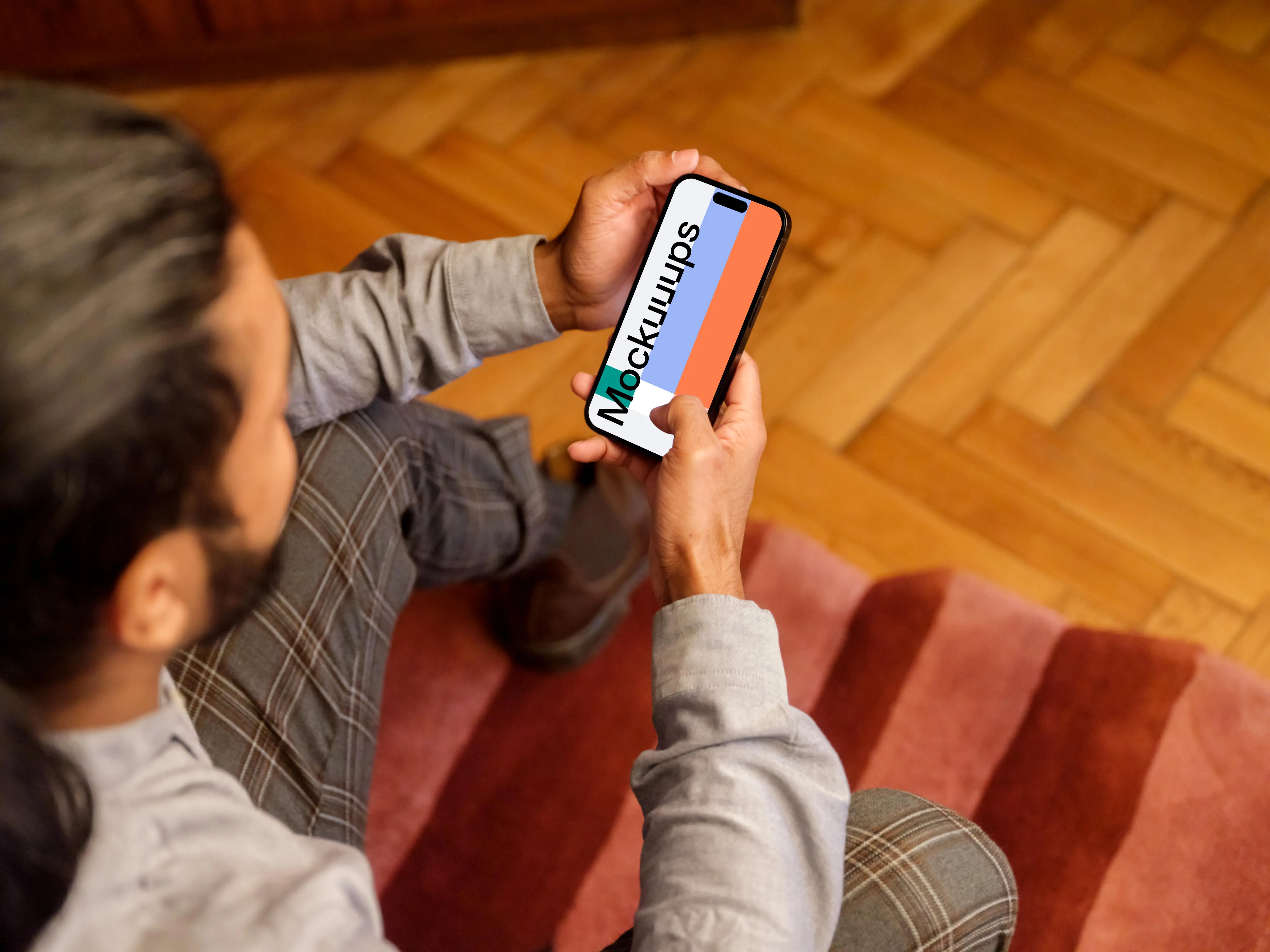Man typing on a iPhone 14 Pro mockup in the office