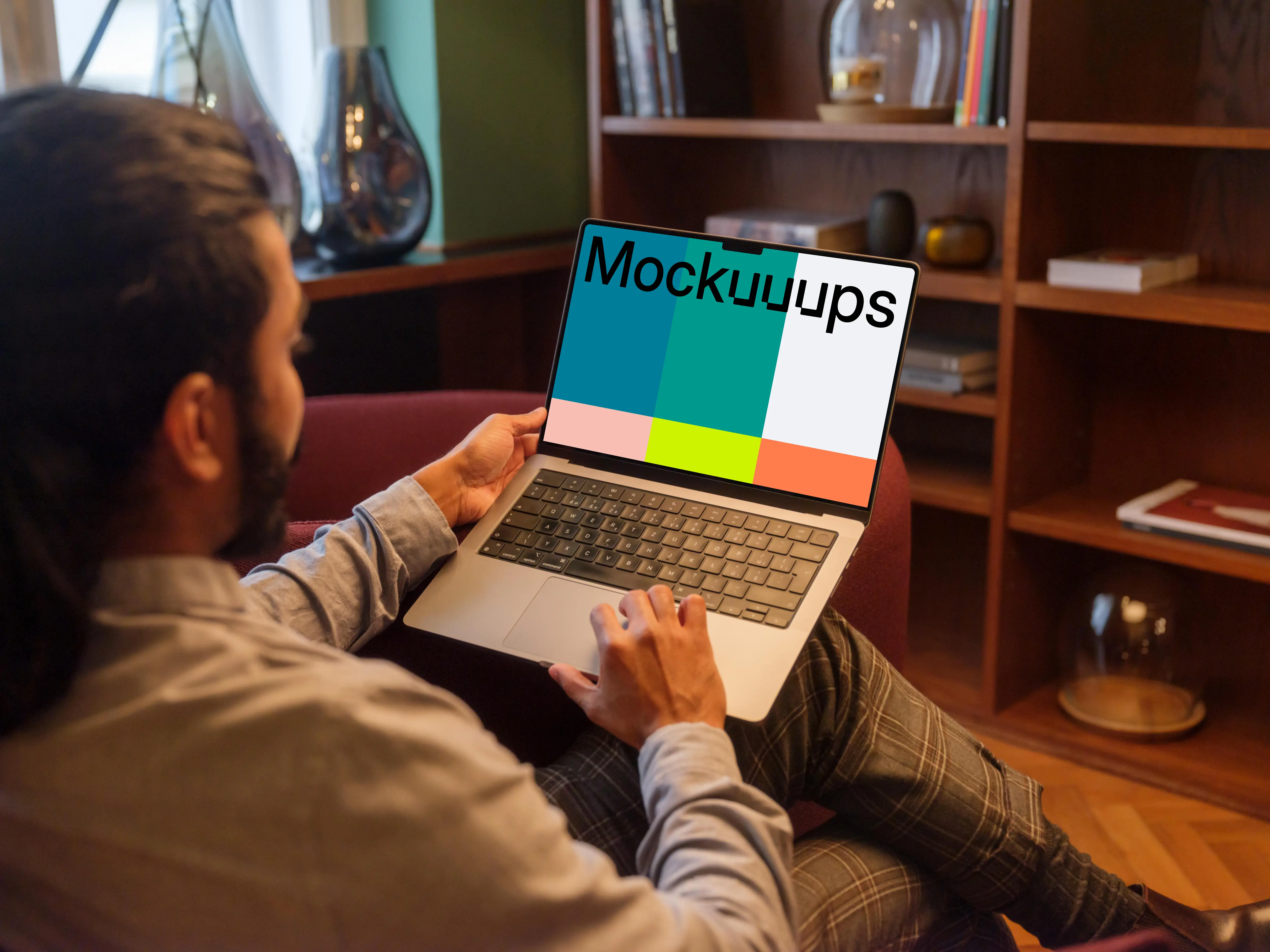 Man working on a MacBook Pro in office