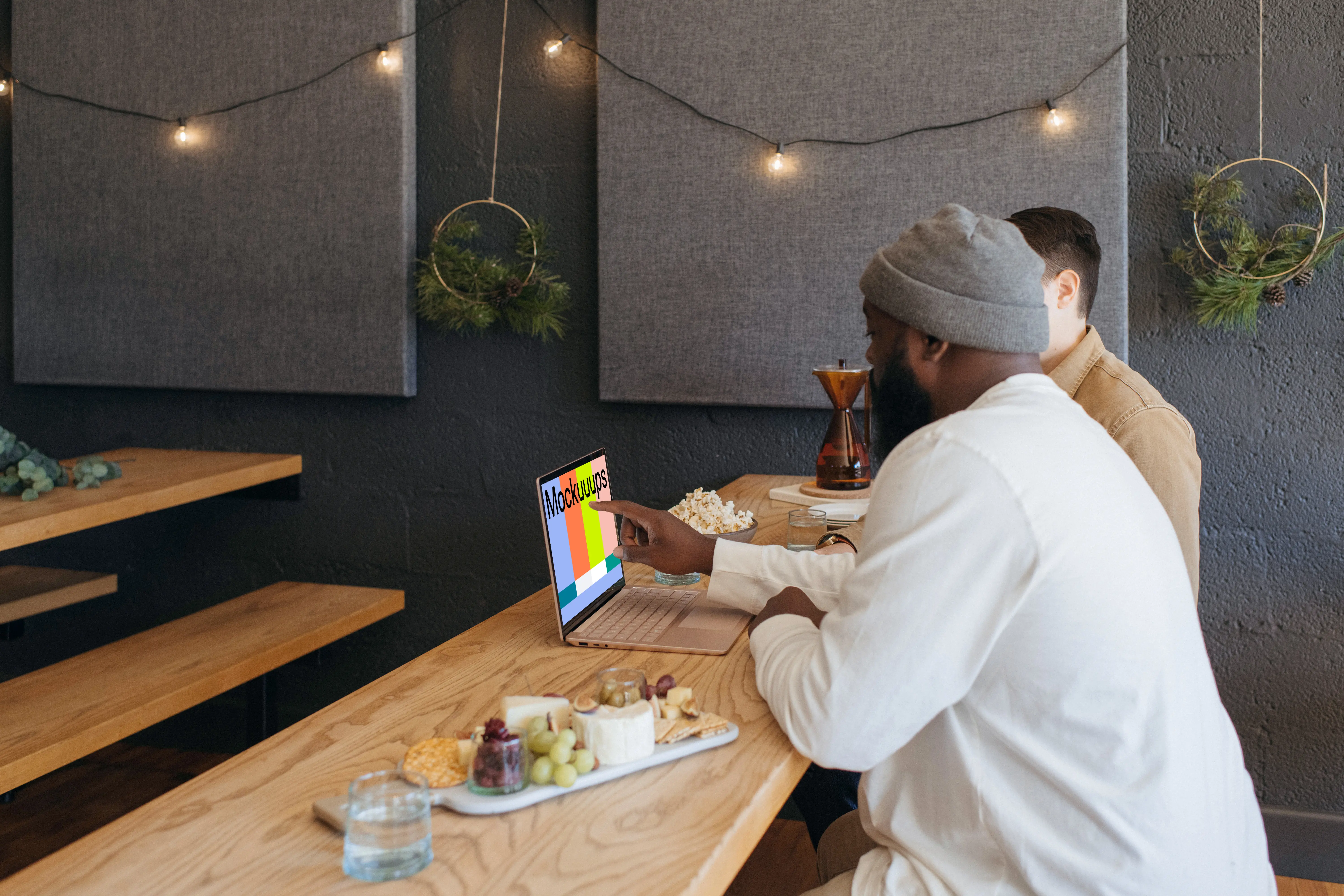Microsoft Surface Laptop mockup in a restaurant with two users