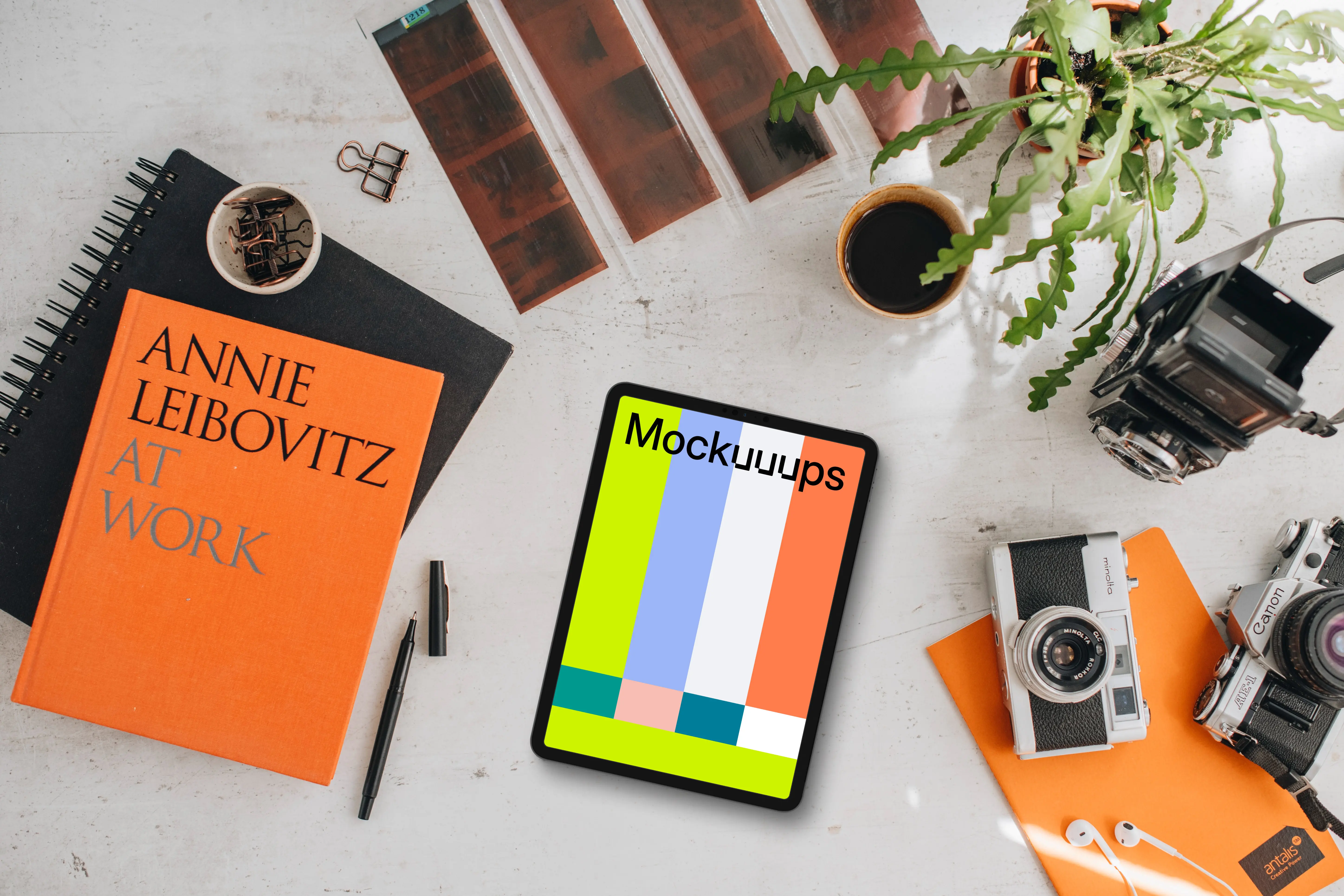 Mockup of tablet device next to the colorful books